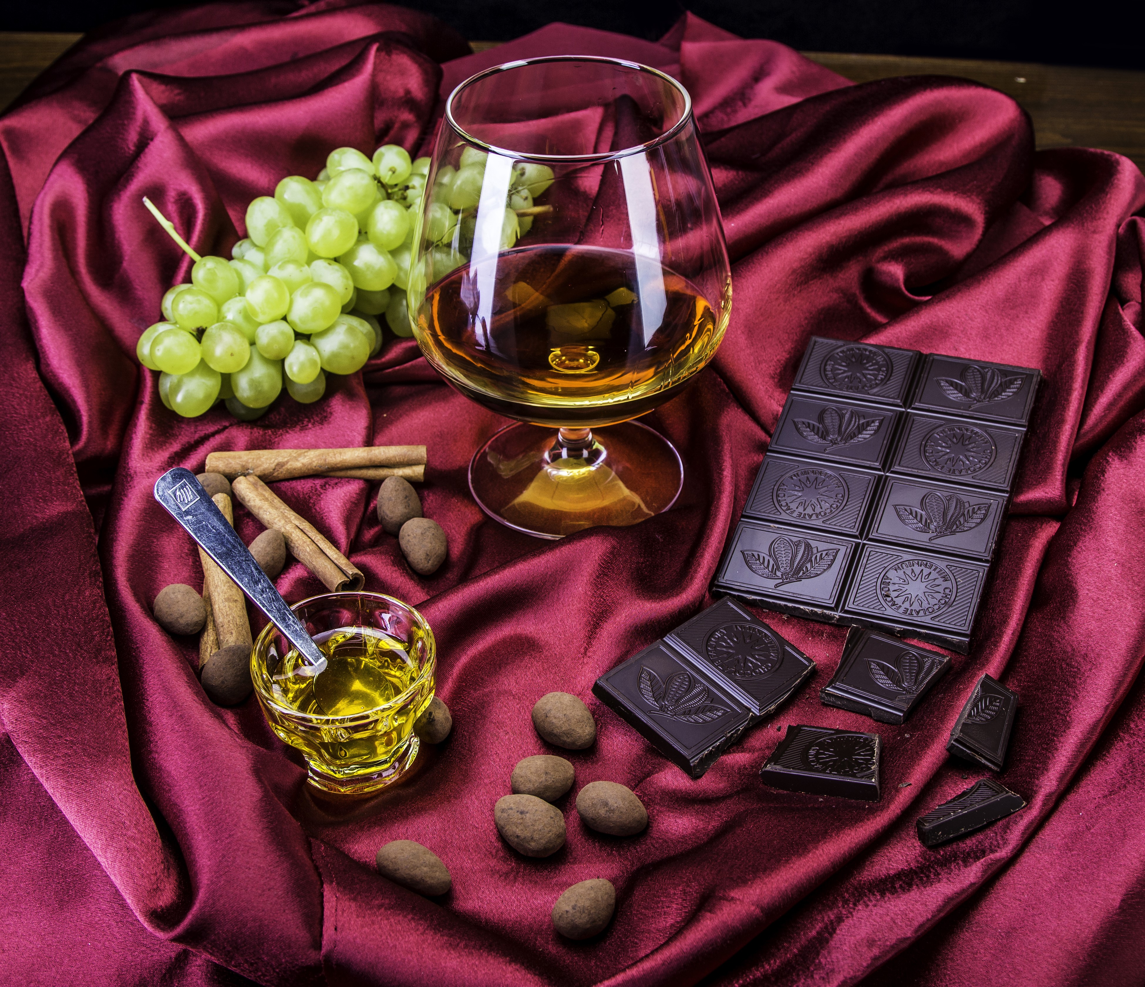 Still-life with brandy, chocolate, grapes, and cinnamon HD Wallpaper