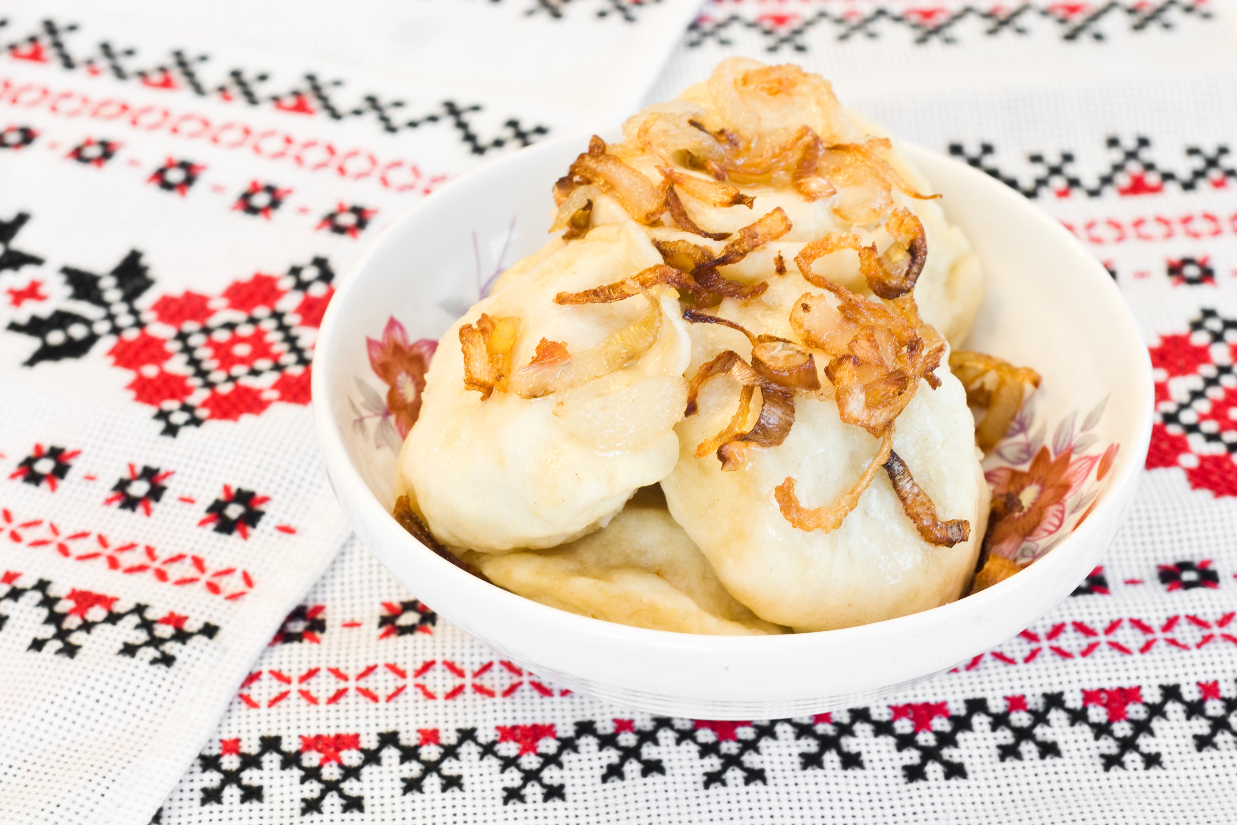 Pierogi varenyky with fried onions in a bowl HD Wallpaper