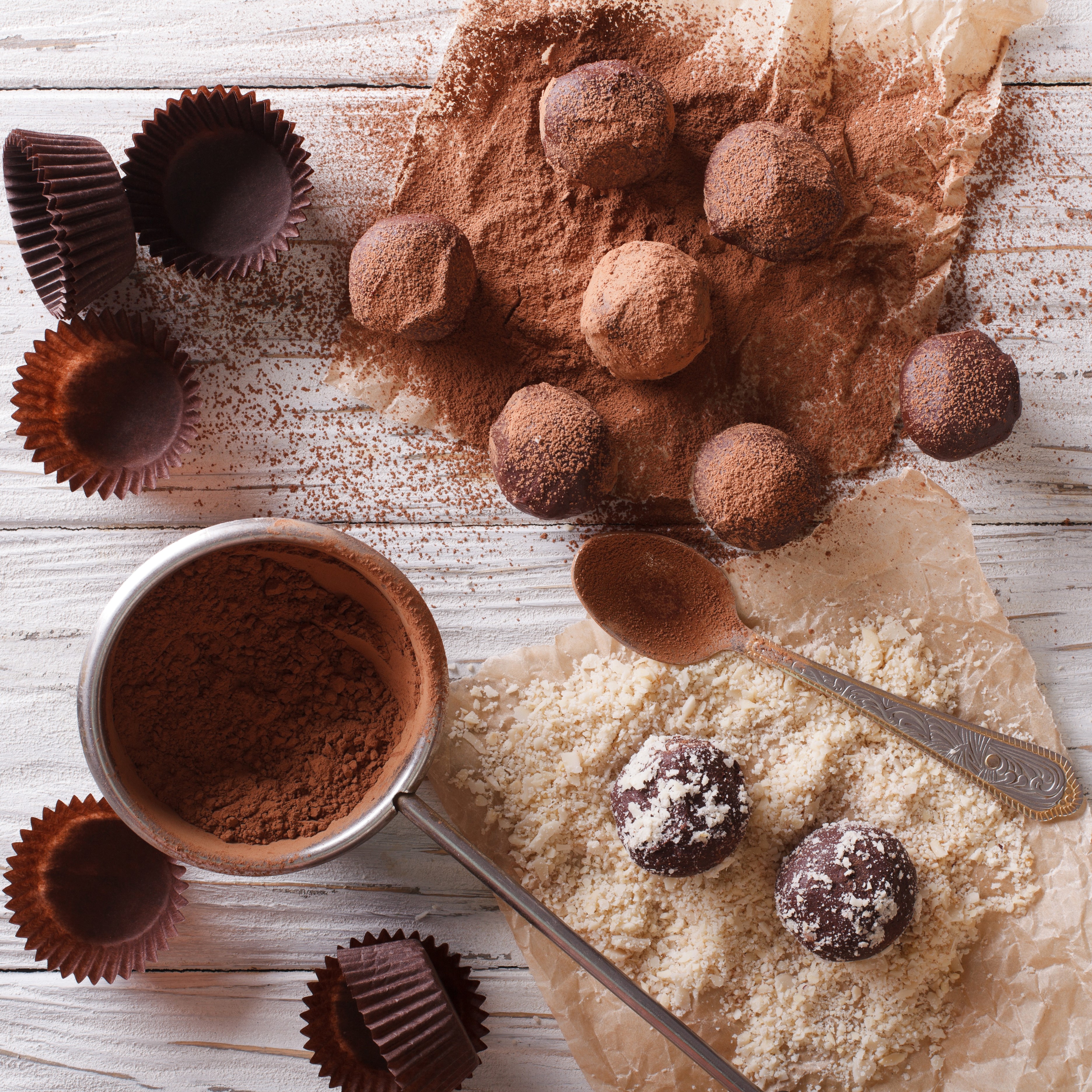 Chocolate truffles dusted with cocoa powder and nuts HD Wallpaper