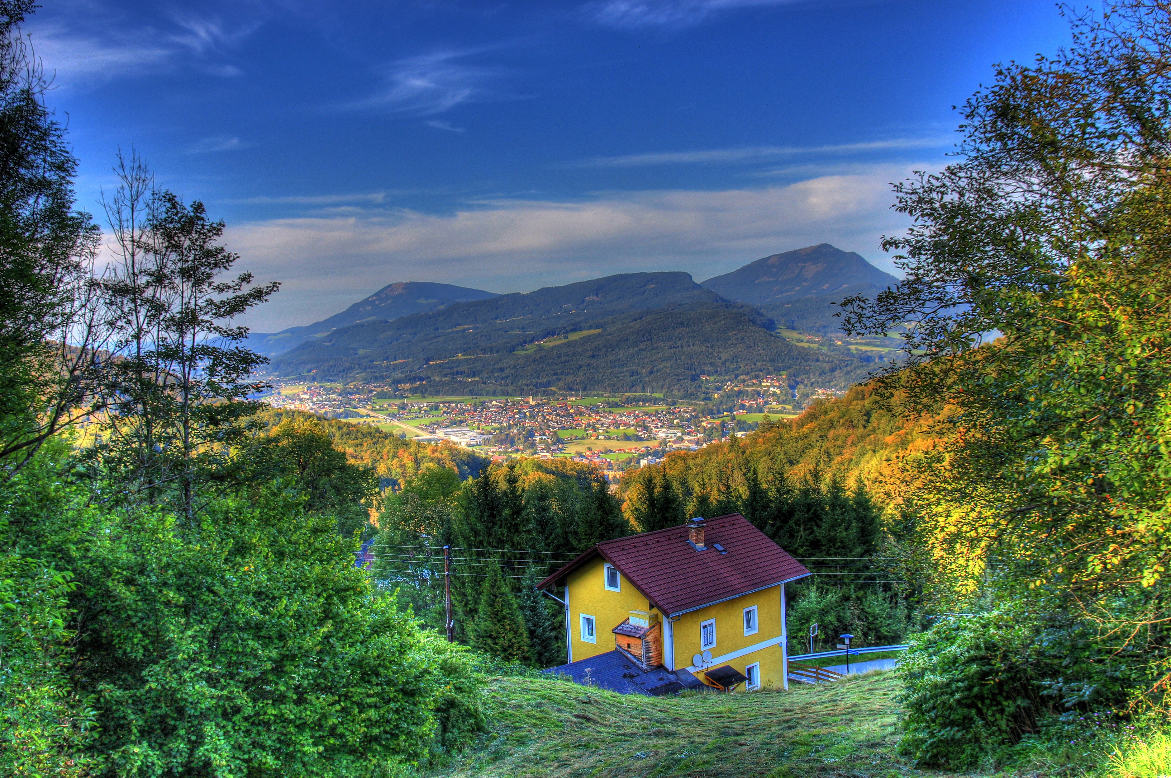 Yellow house in Hallein, Austria with mountains in the background HD Wallpaper