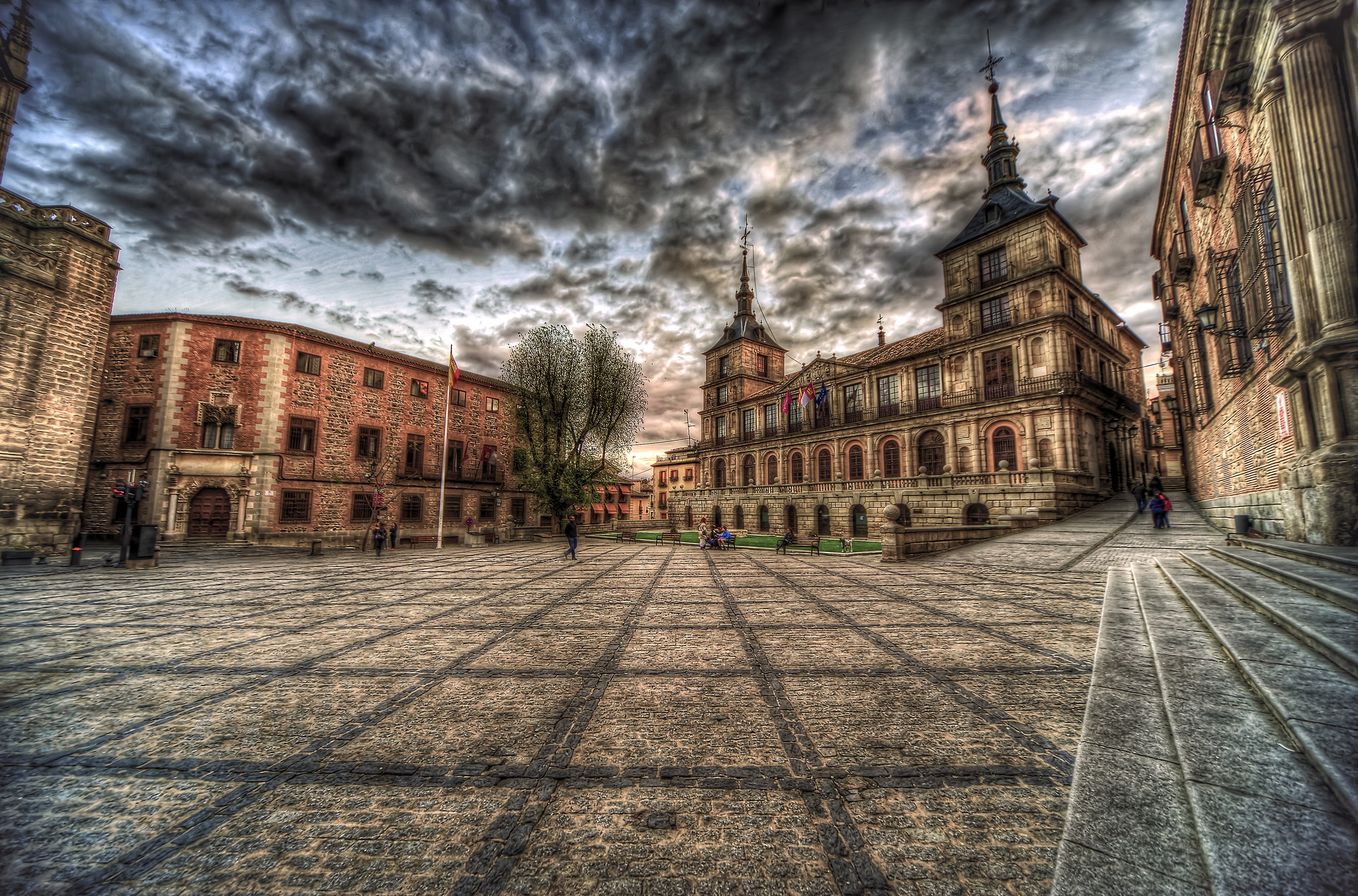 Plaza in Toledo, Spain with historic buildings and cloudy sky HD Wallpaper