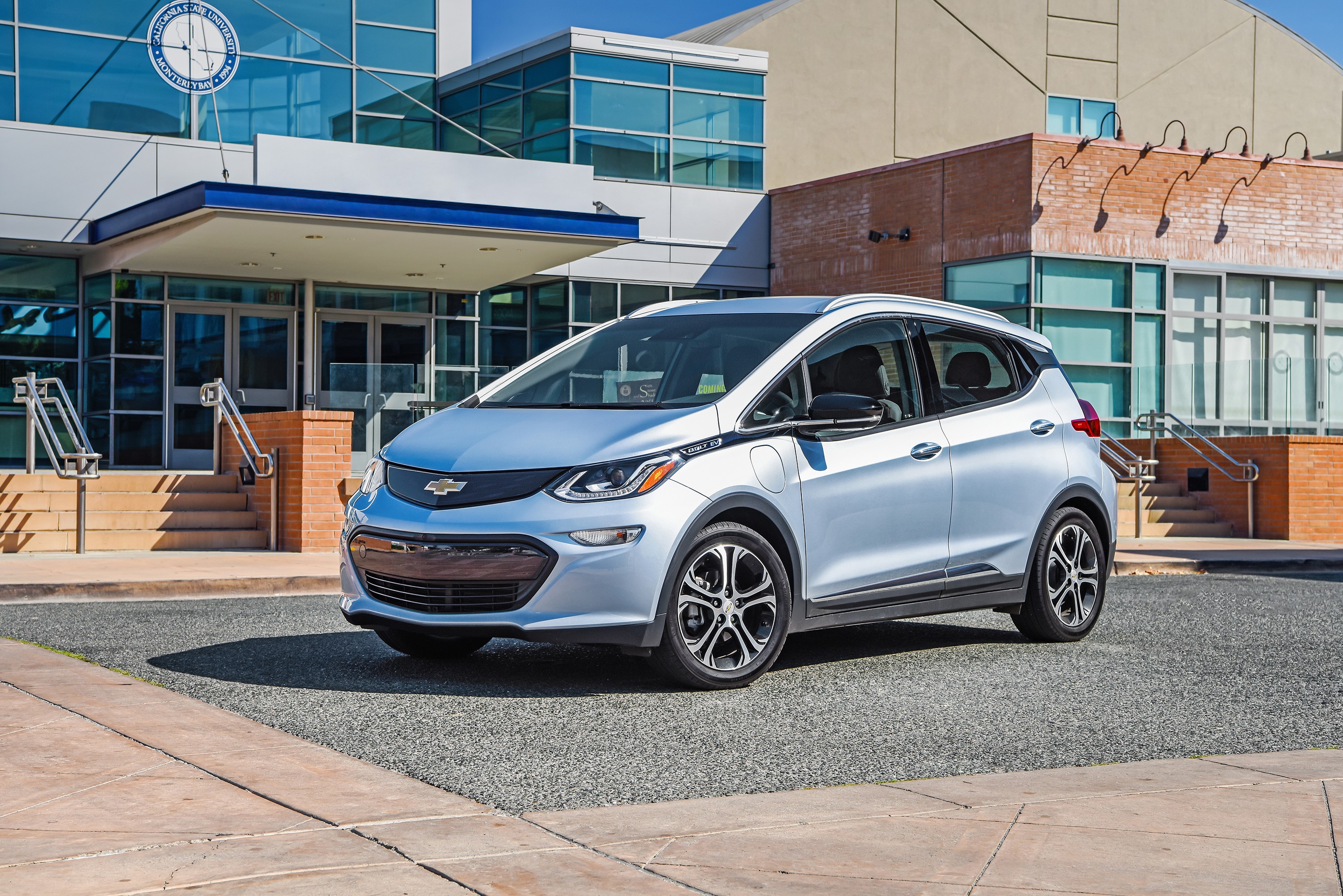 Silver 2017 Chevrolet Bolt EV parked outside building HD Wallpaper