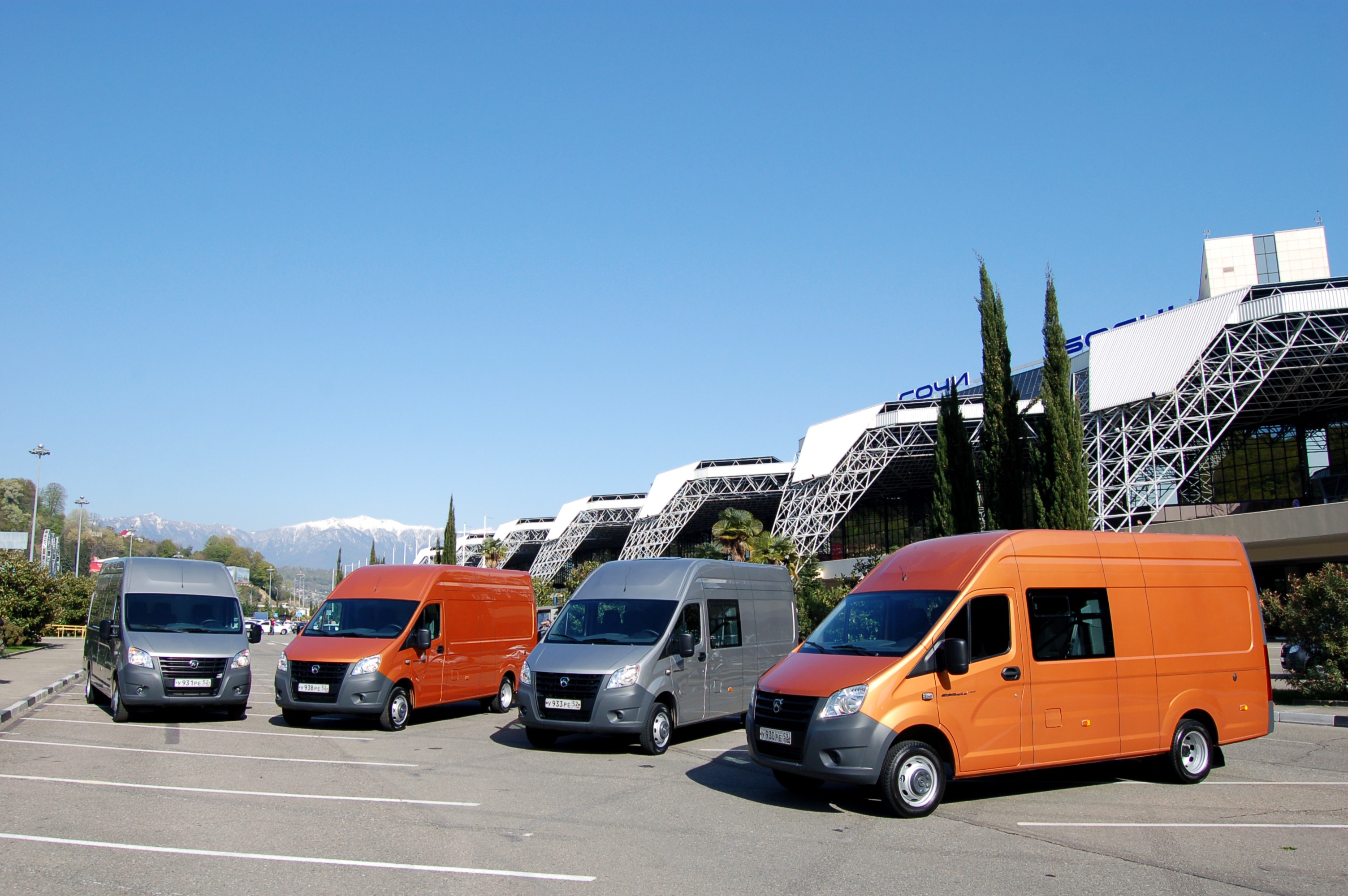 GAZelle Next vans parked in front of a modern building HD Wallpaper