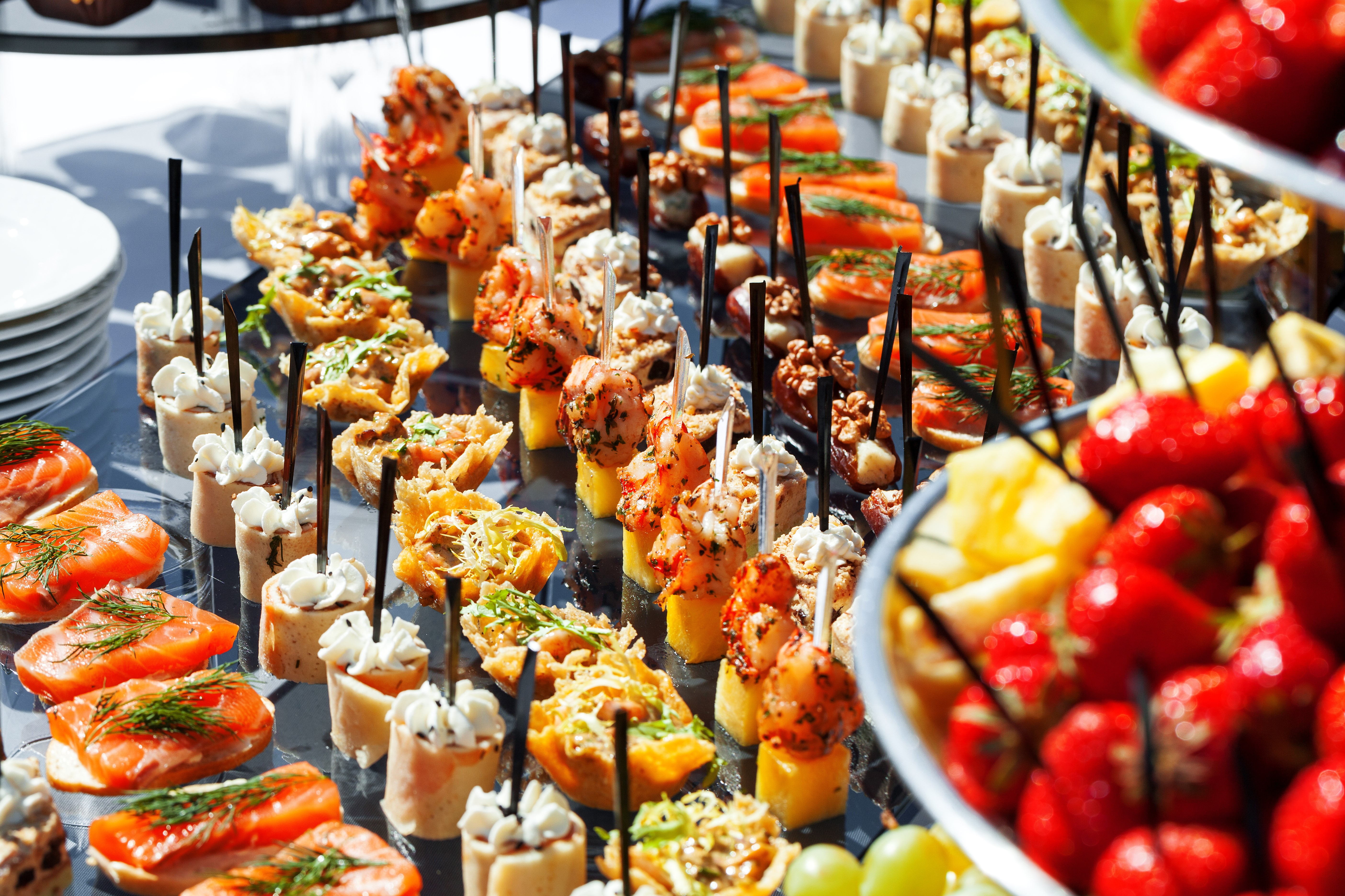 Assortment of appetizers and fruits on a table HD Wallpaper