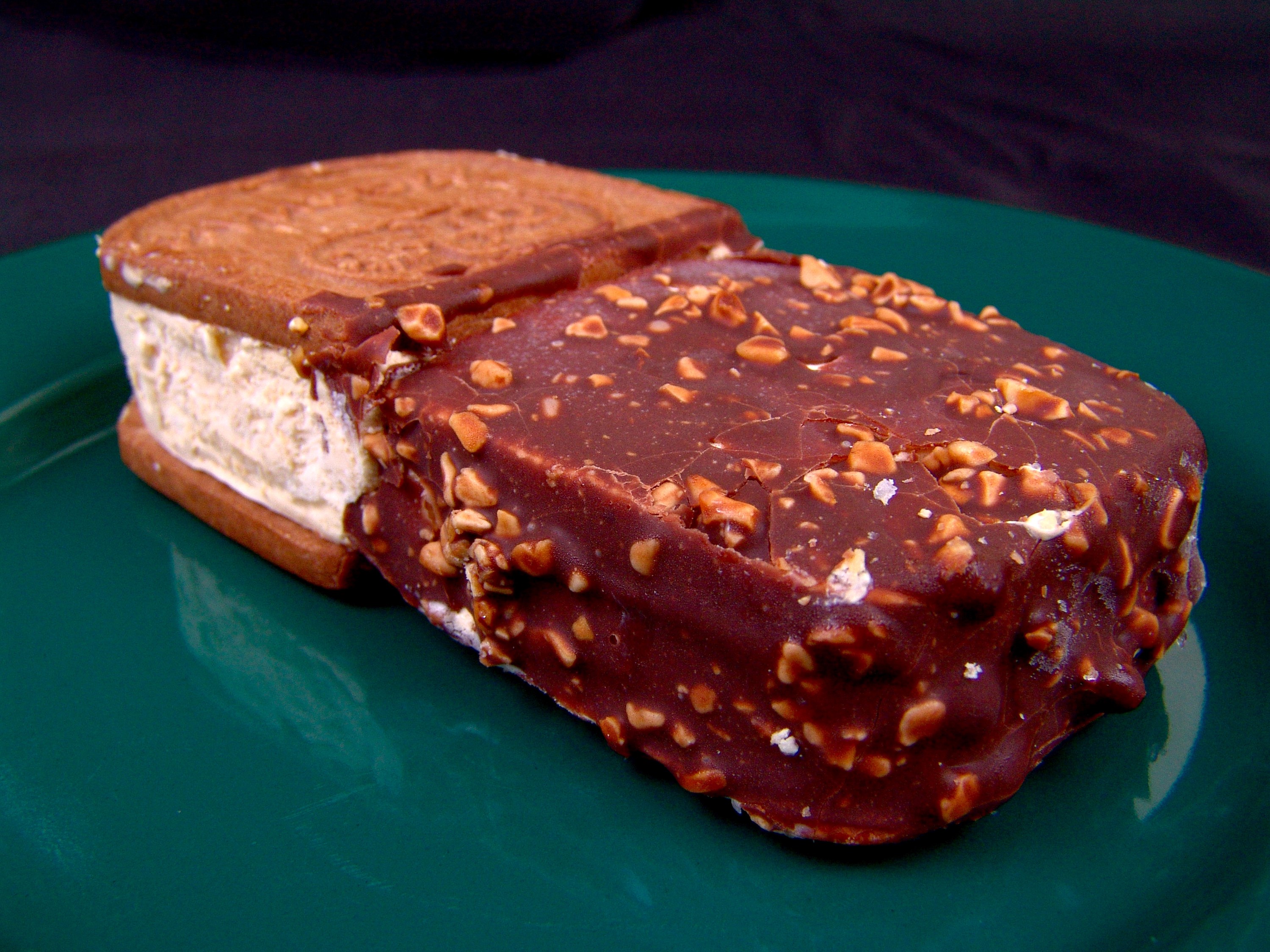 Chocolate-covered ice cream sandwich with nuts HD Wallpaper