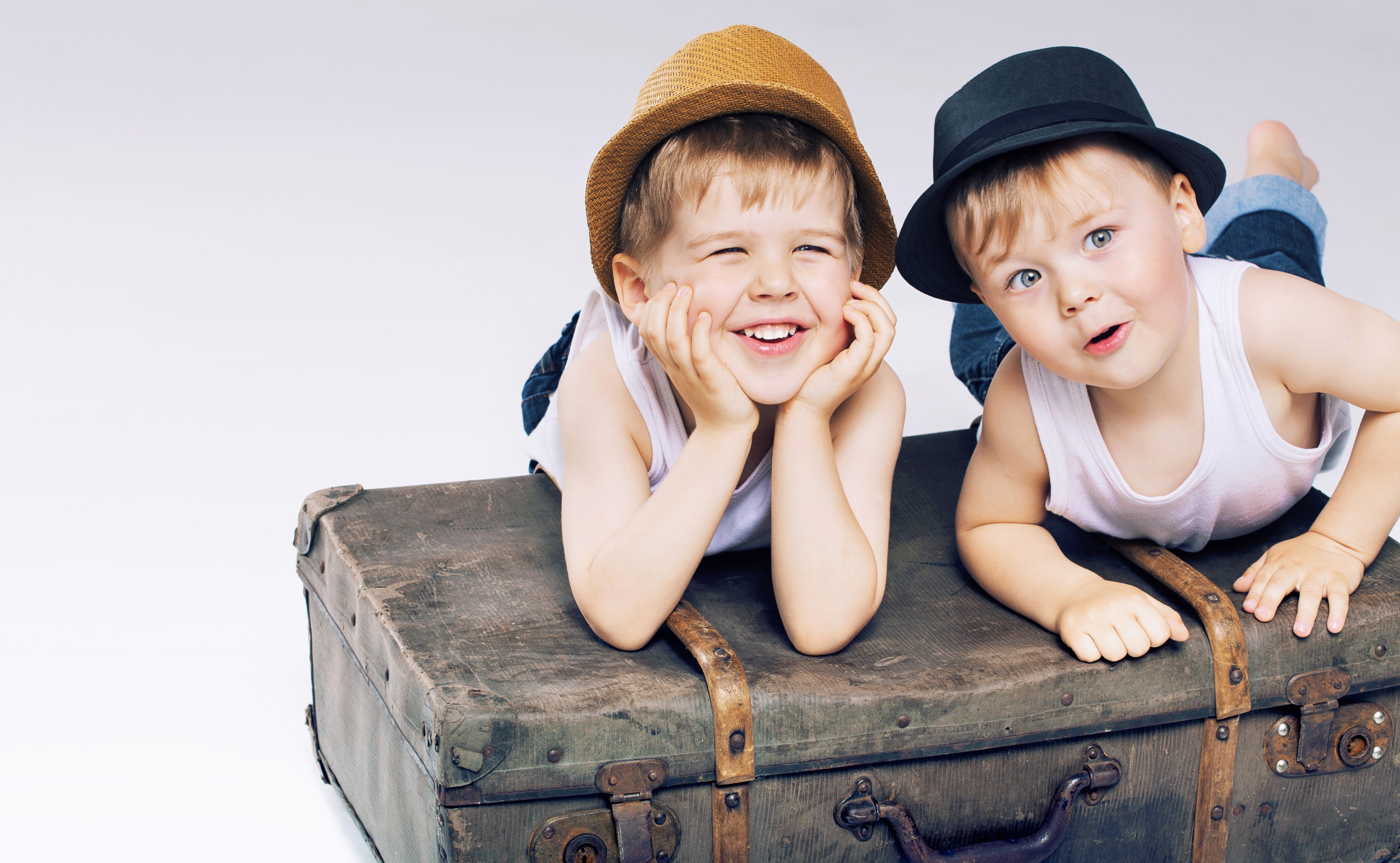 Two cute boys in hats on a suitcase HD Wallpaper