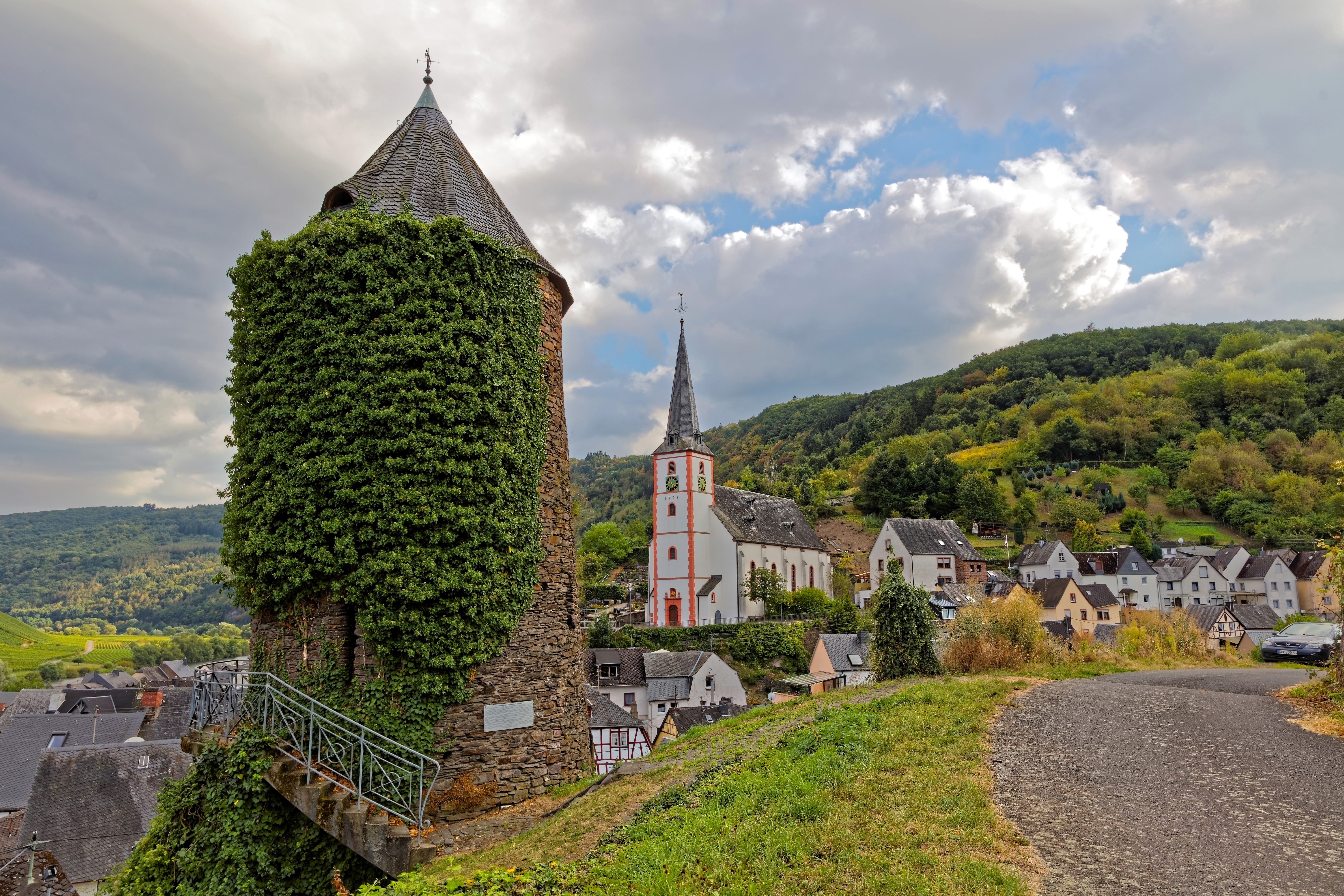 Vine-covered tower and church in Briedel, Germany HD Wallpaper