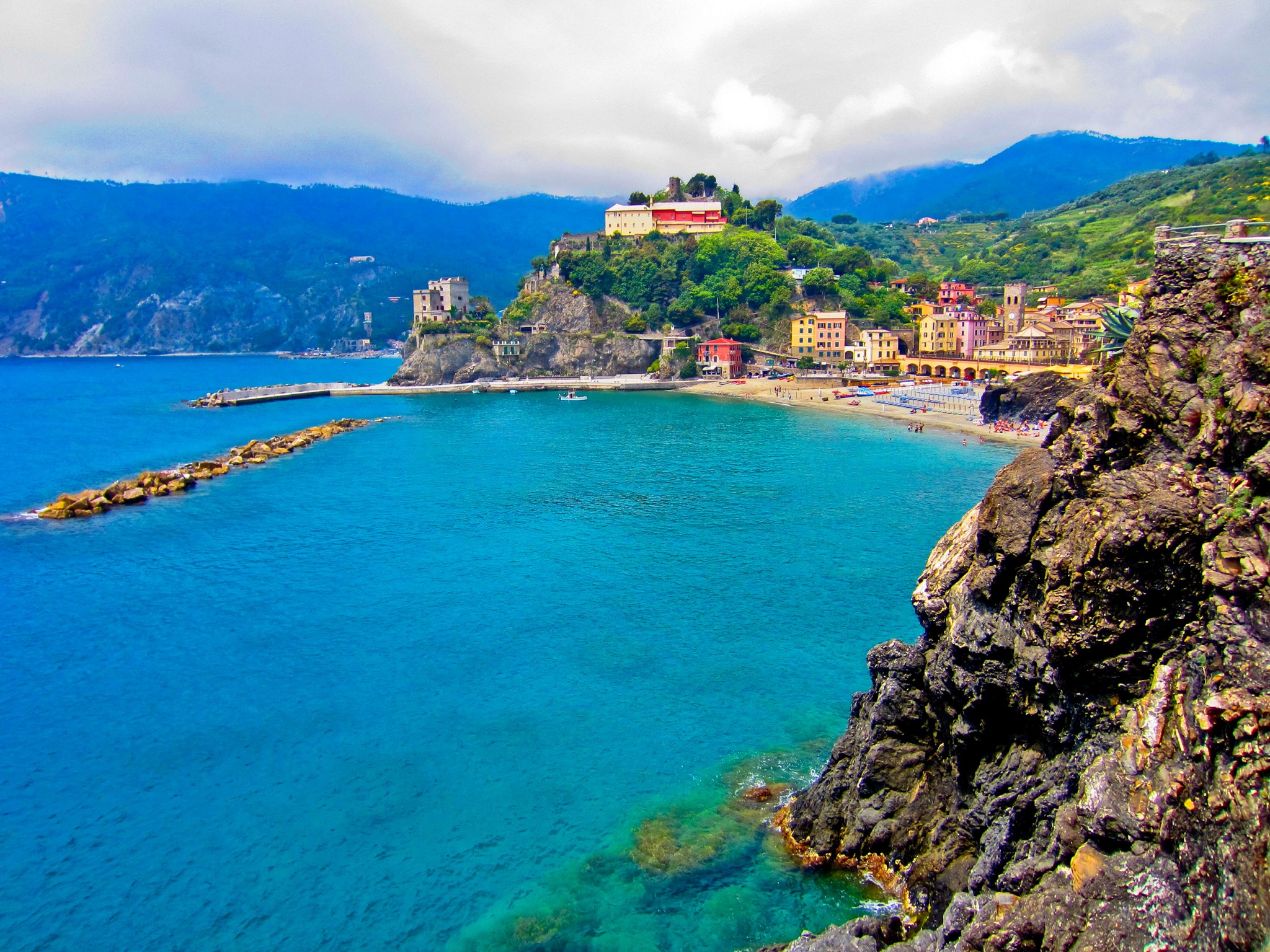 Coastal village with colorful houses and a beach in Italy HD Wallpaper