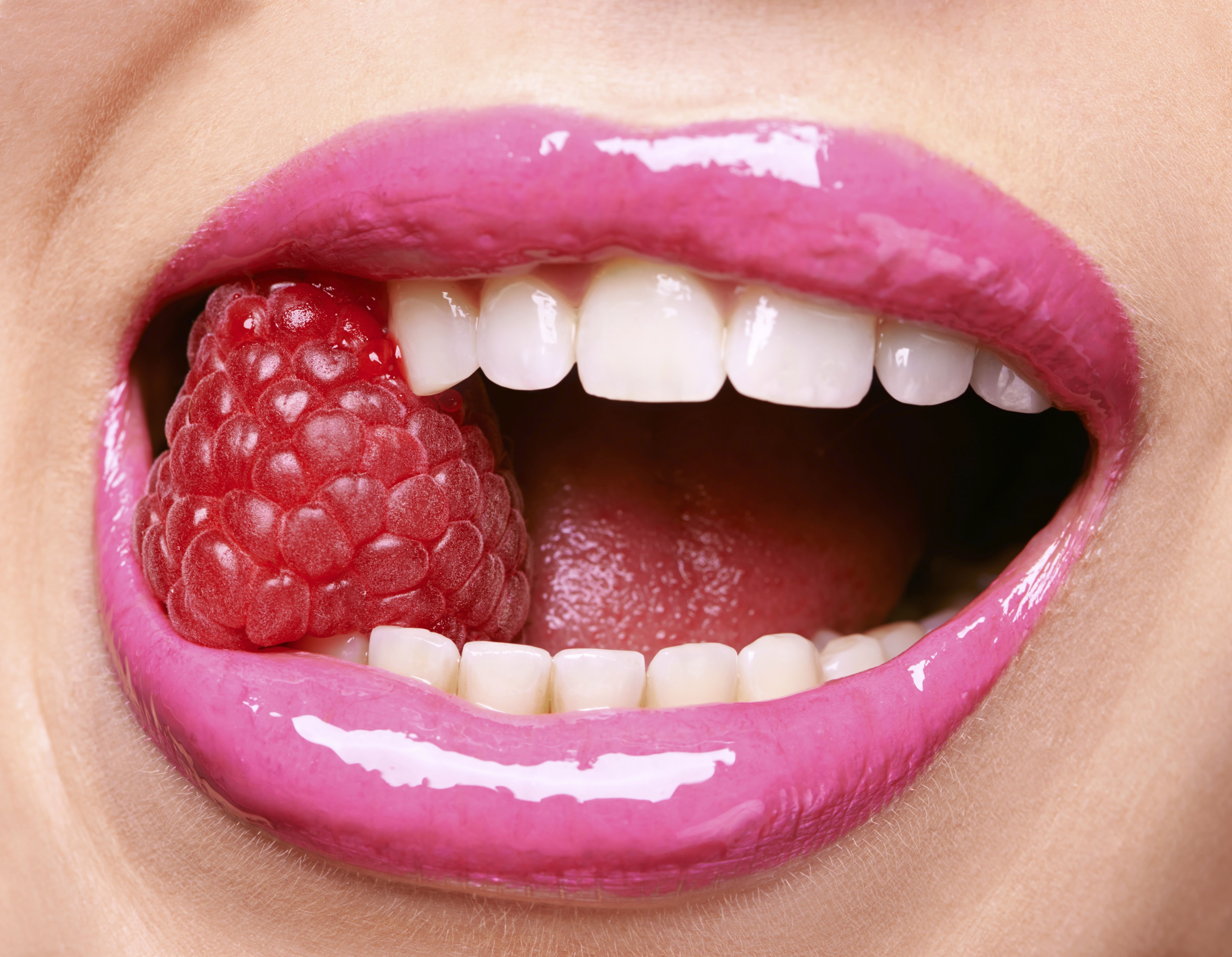 Close-up of lips with raspberry and teeth HD Wallpaper