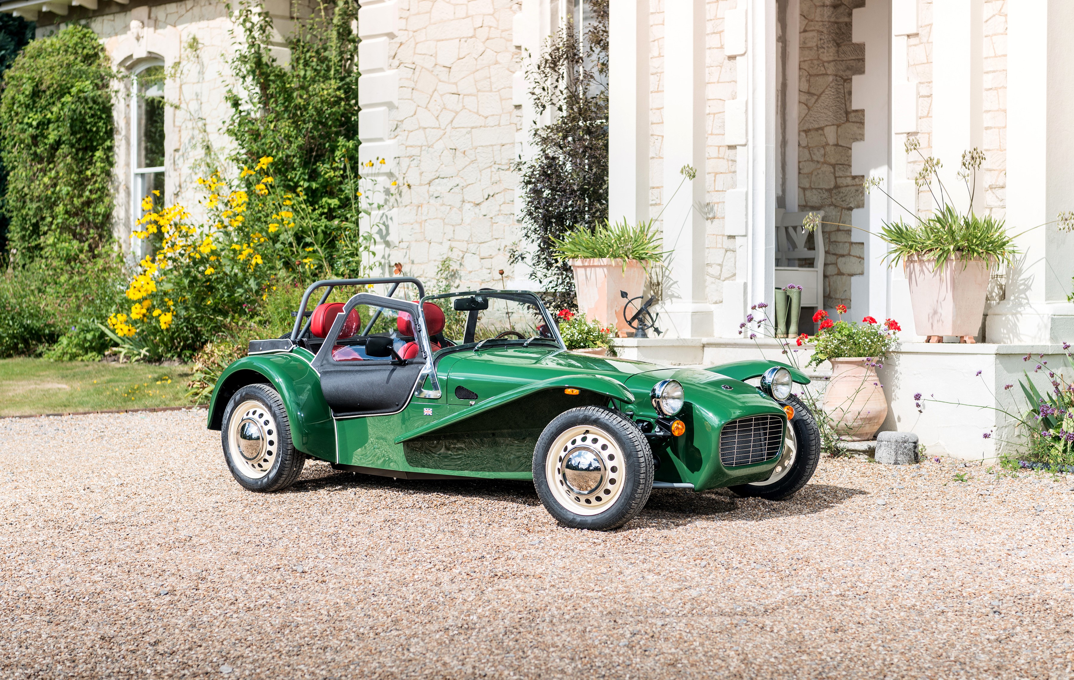 Green Caterham 7 Sprint parked in front of a house HD Wallpaper