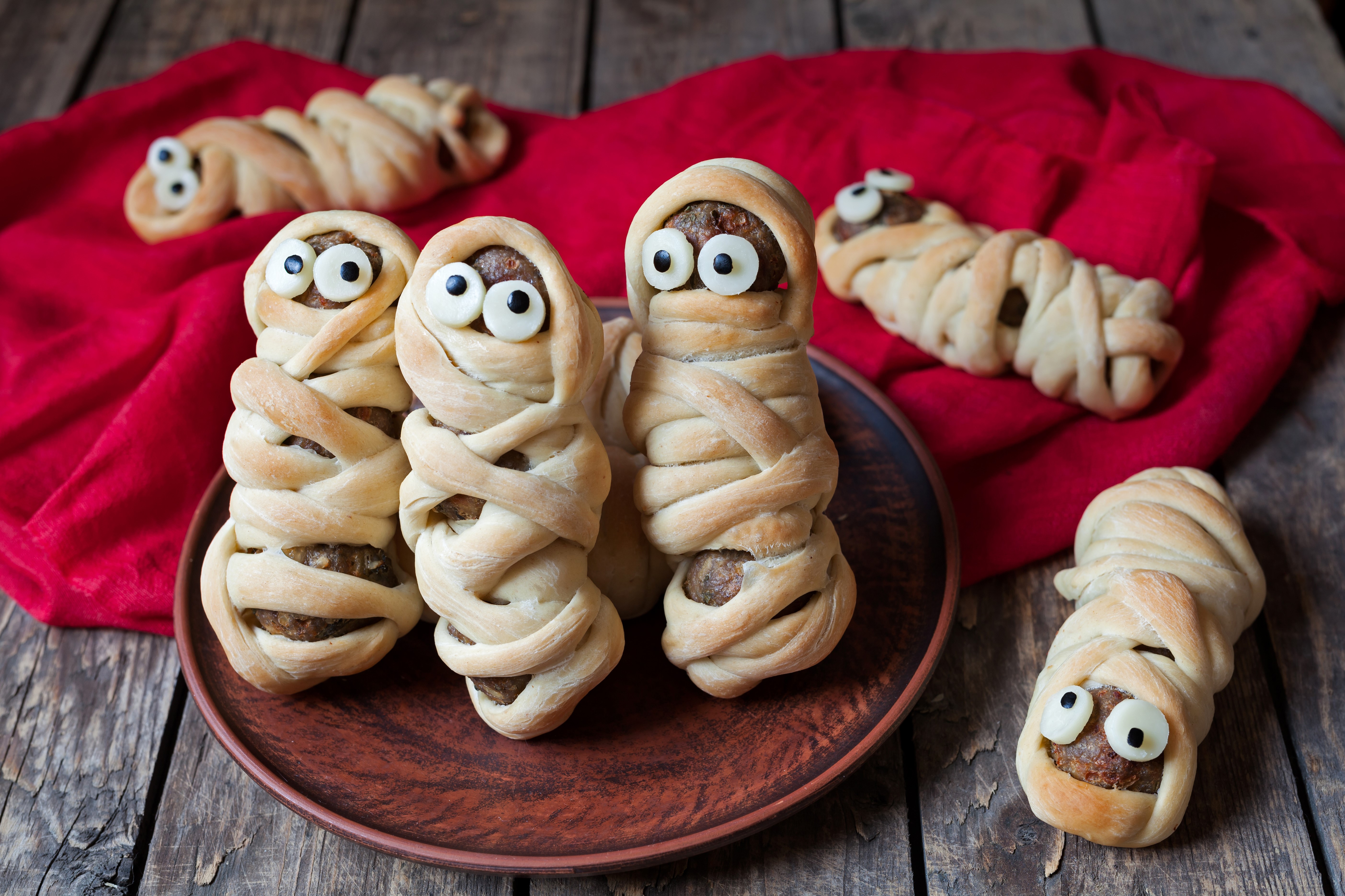 Mummy-shaped meat products with candy eyes HD Wallpaper