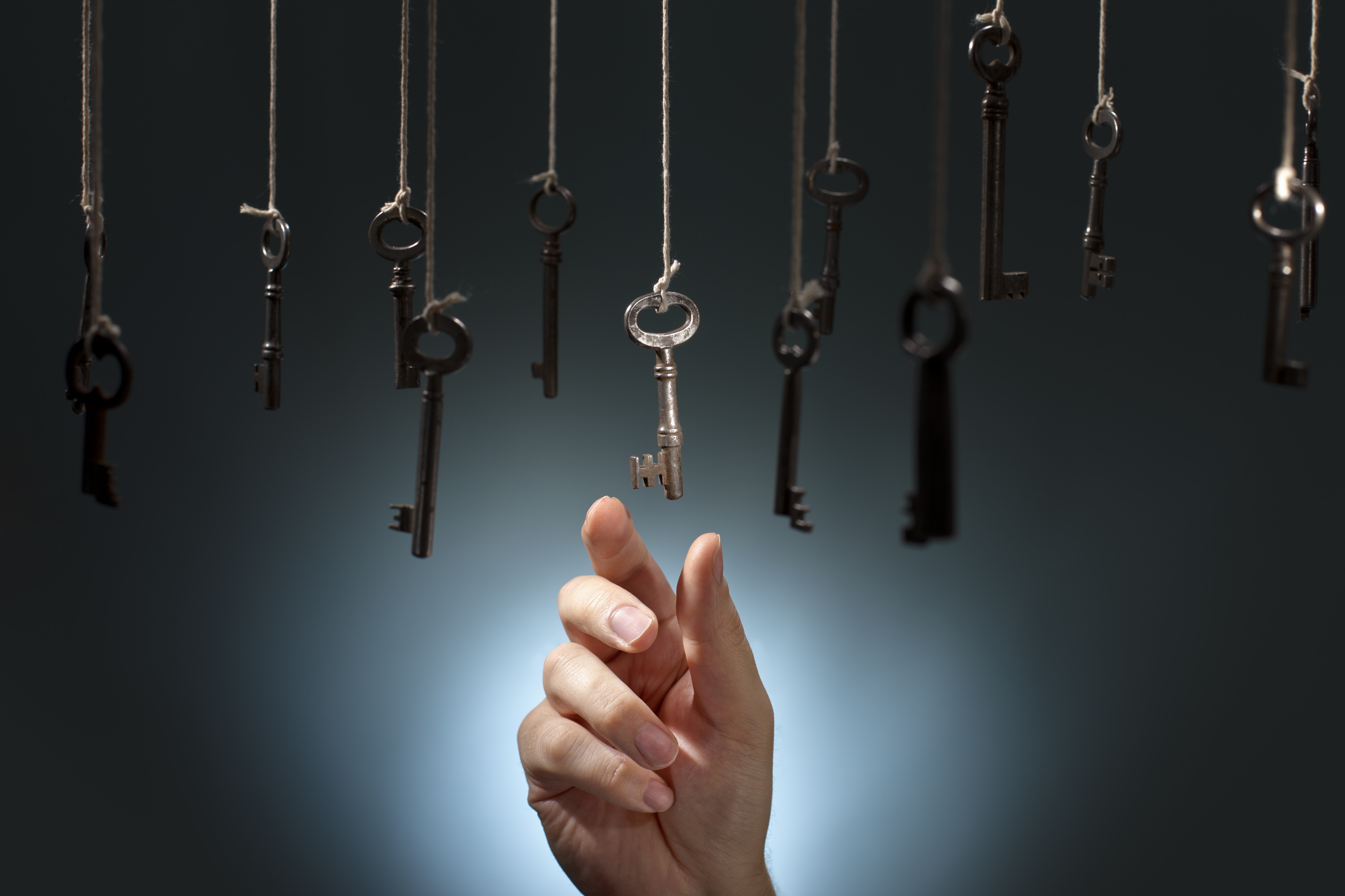 Hand reaching for hanging keys HD Wallpaper