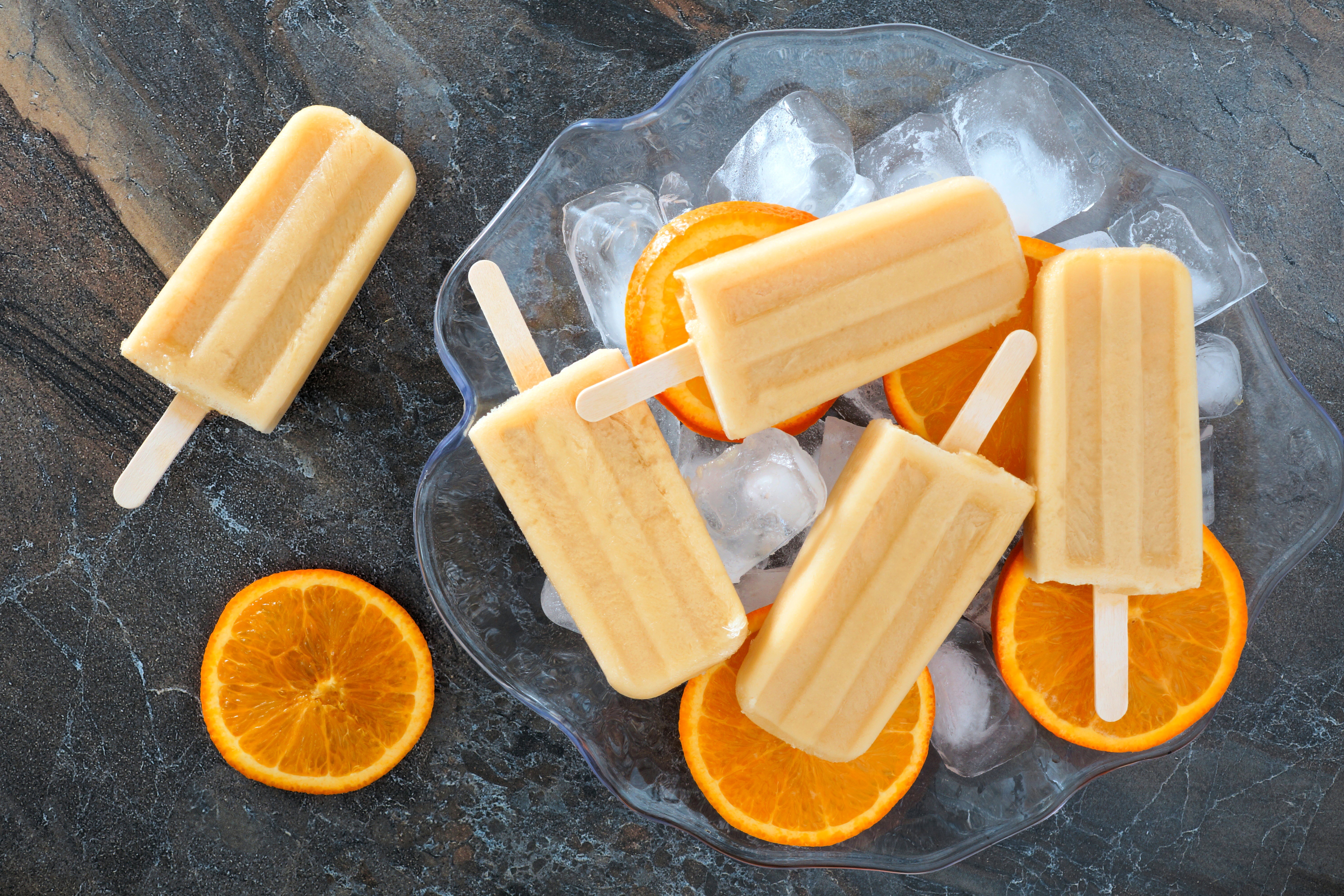 Orange popsicles with ice and orange slices HD Wallpaper