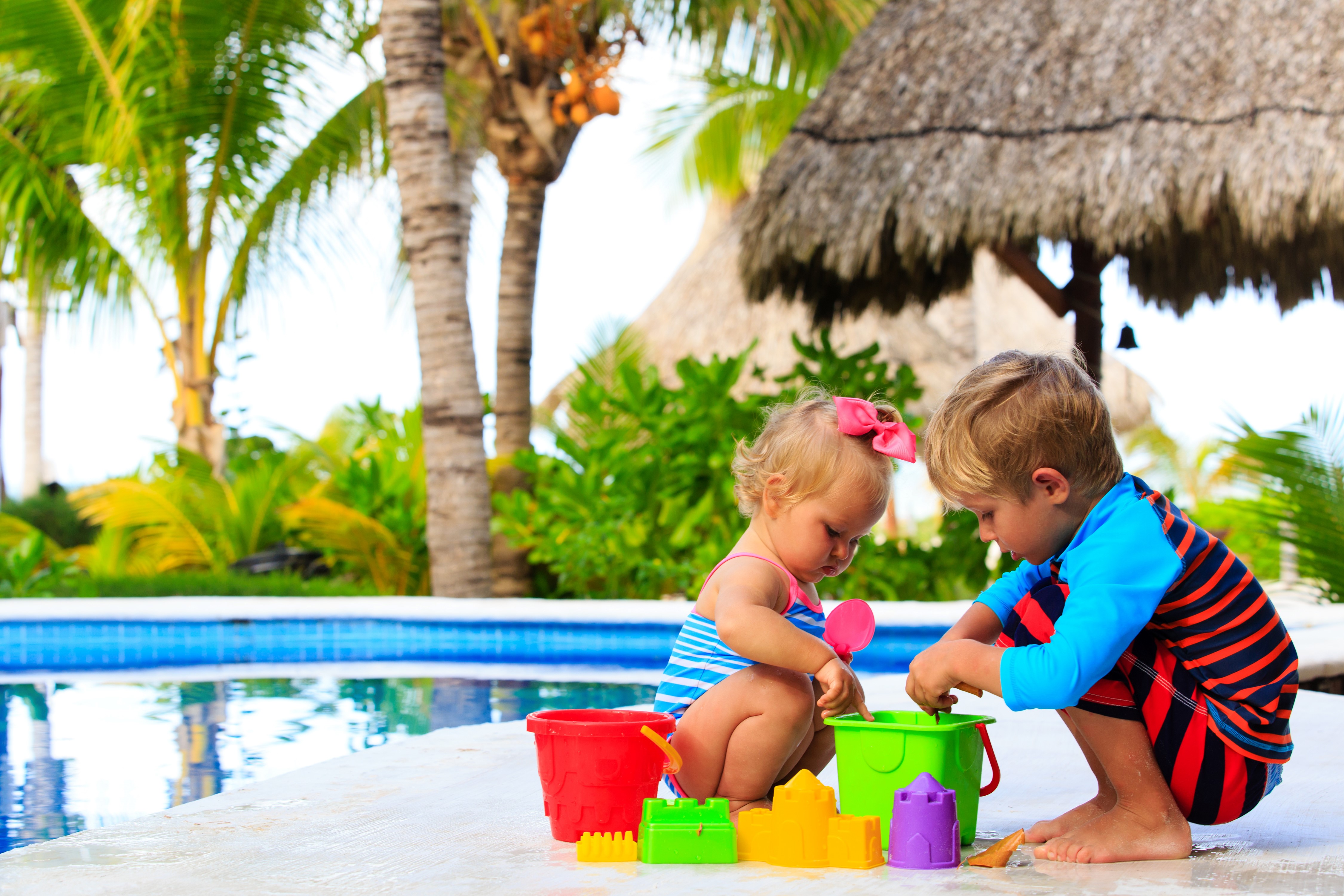 Children playing with toys by the pool HD Wallpaper