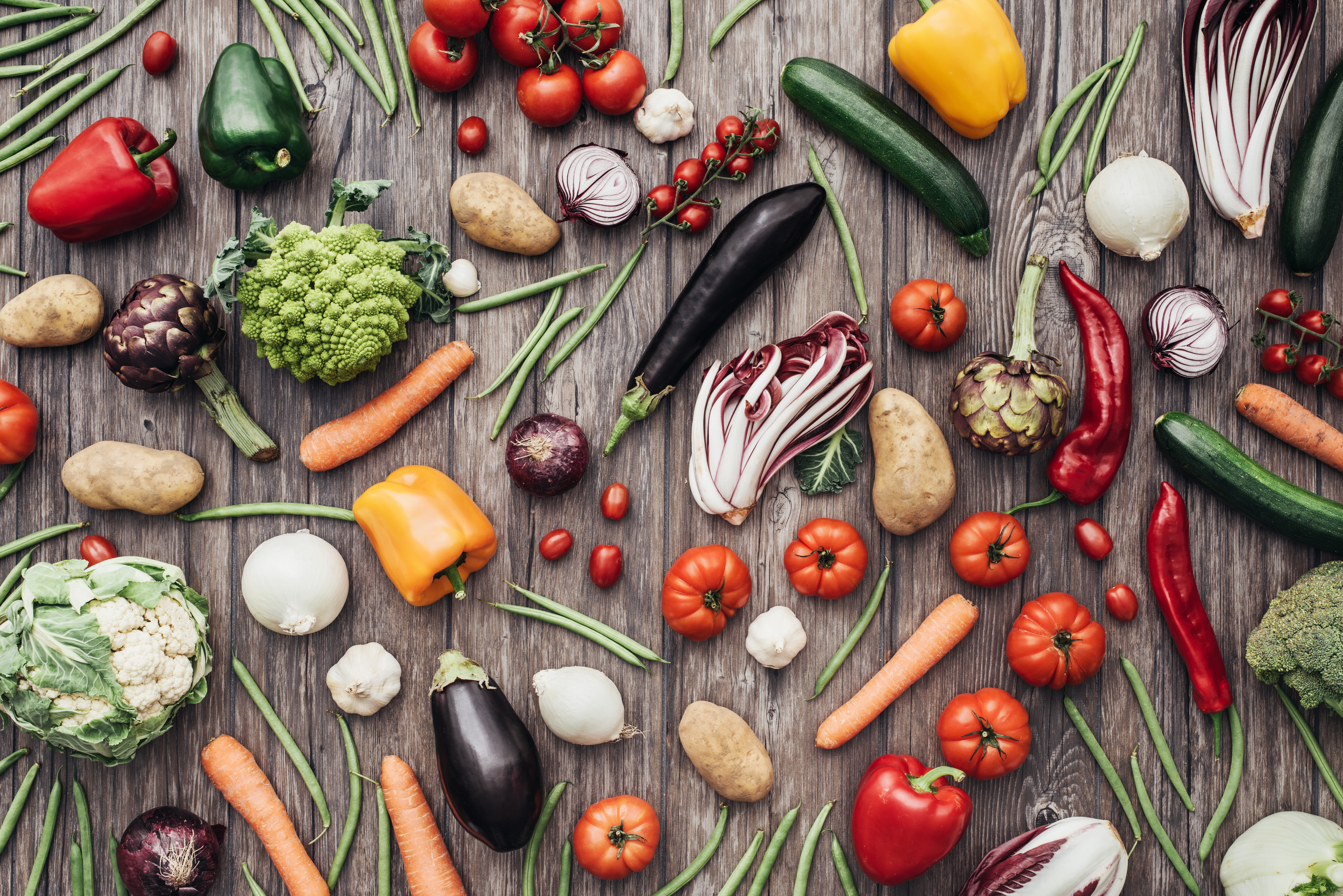 Assortment of fresh vegetables and fruits on a wooden table HD Wallpaper