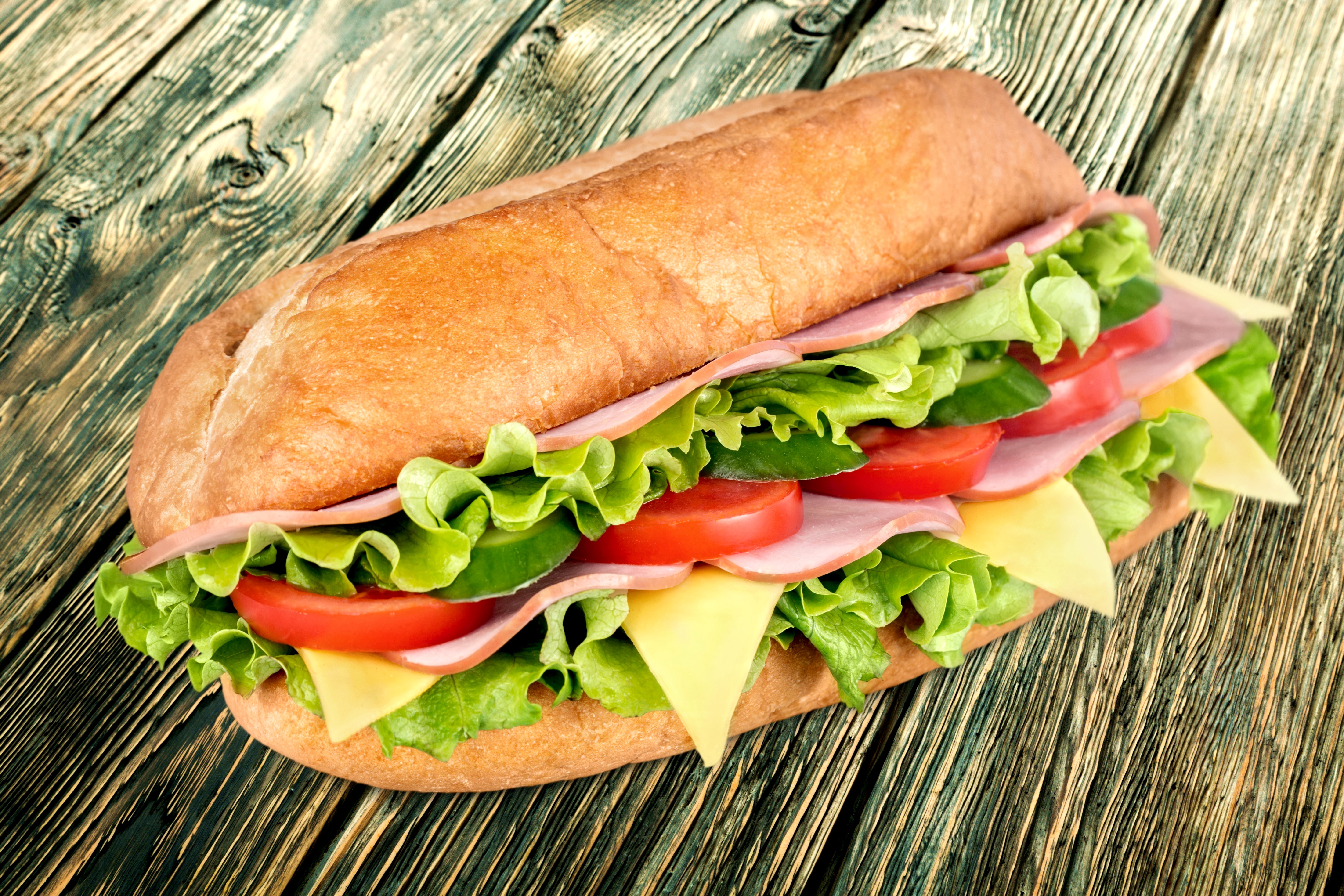 Submarine sandwich with ham, cheese, lettuce, and tomato HD Wallpaper