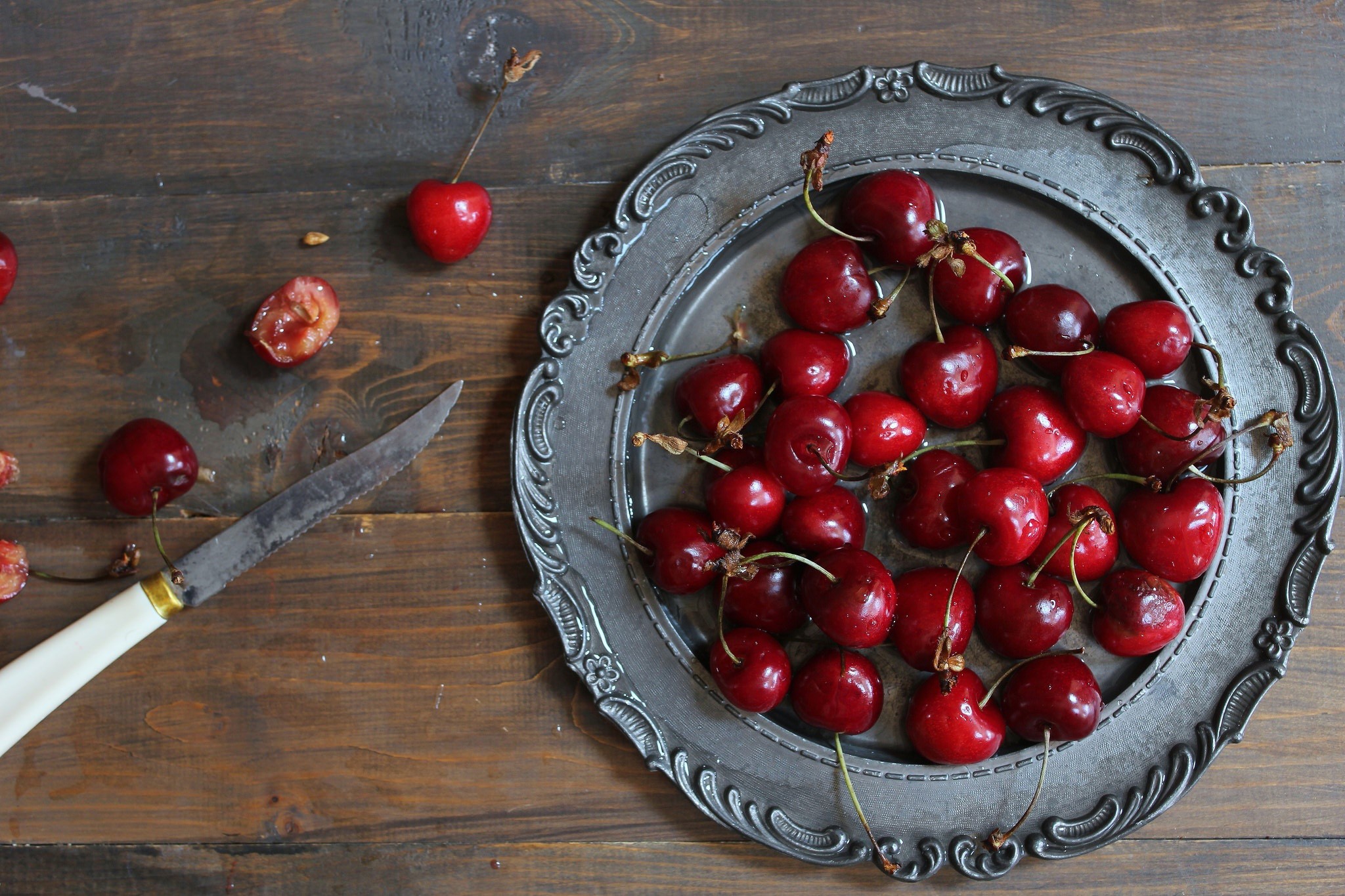 Cherries on a metal plate with a knife HD Wallpaper