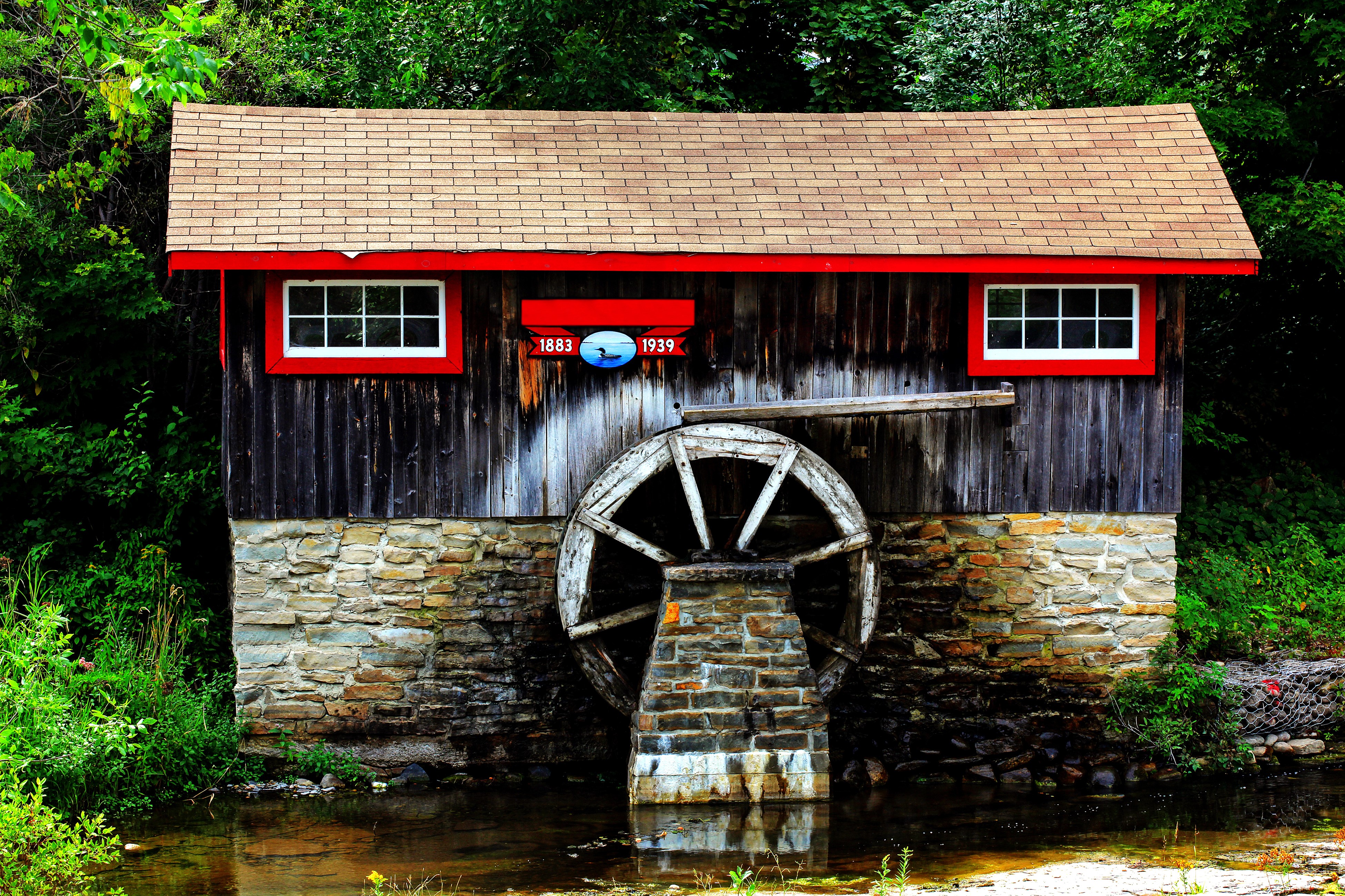 Watermill with a water wheel and stone foundation HD Wallpaper