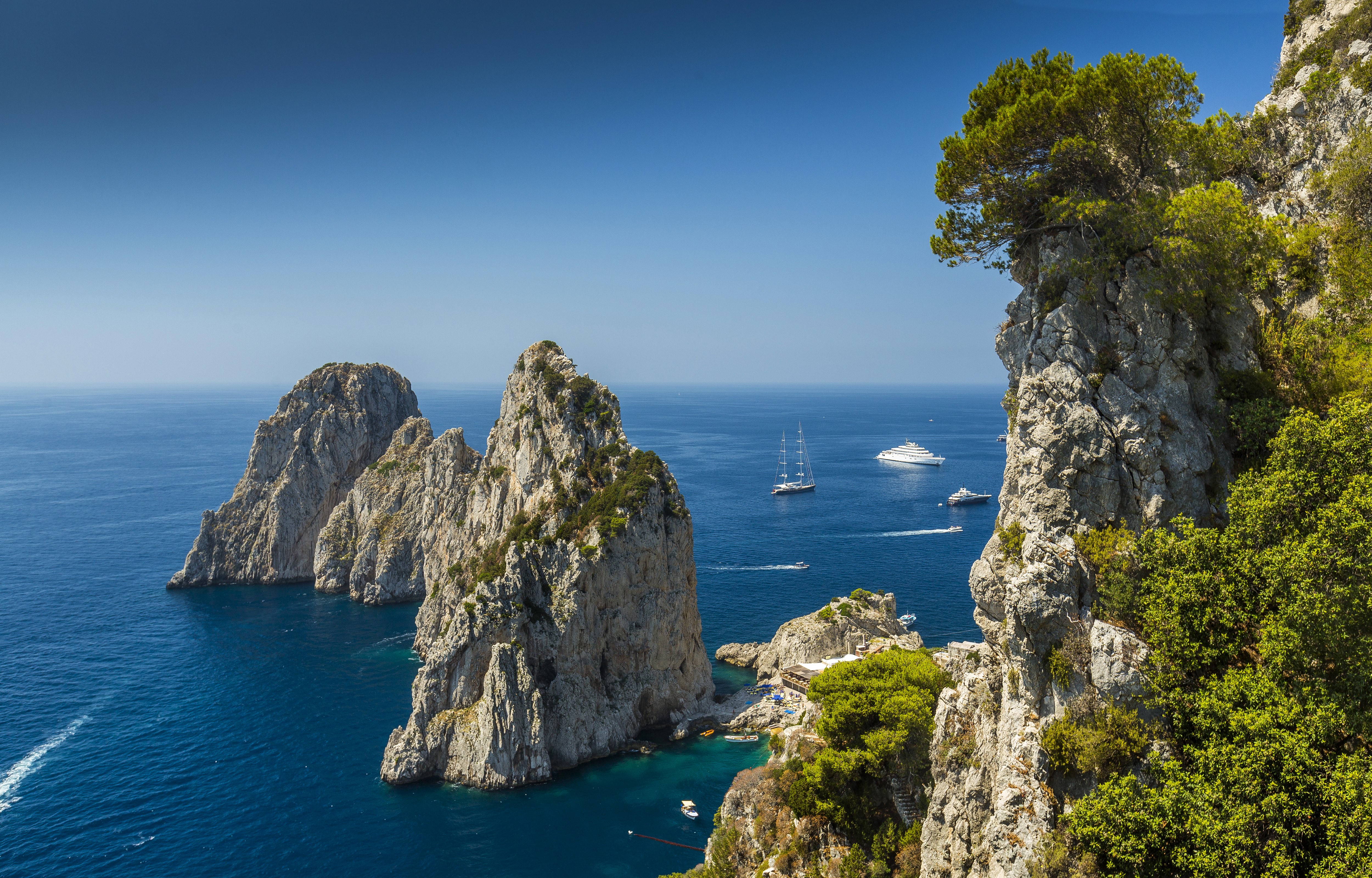 Faraglioni rocks and yachts in Capri, Italy HD Wallpaper