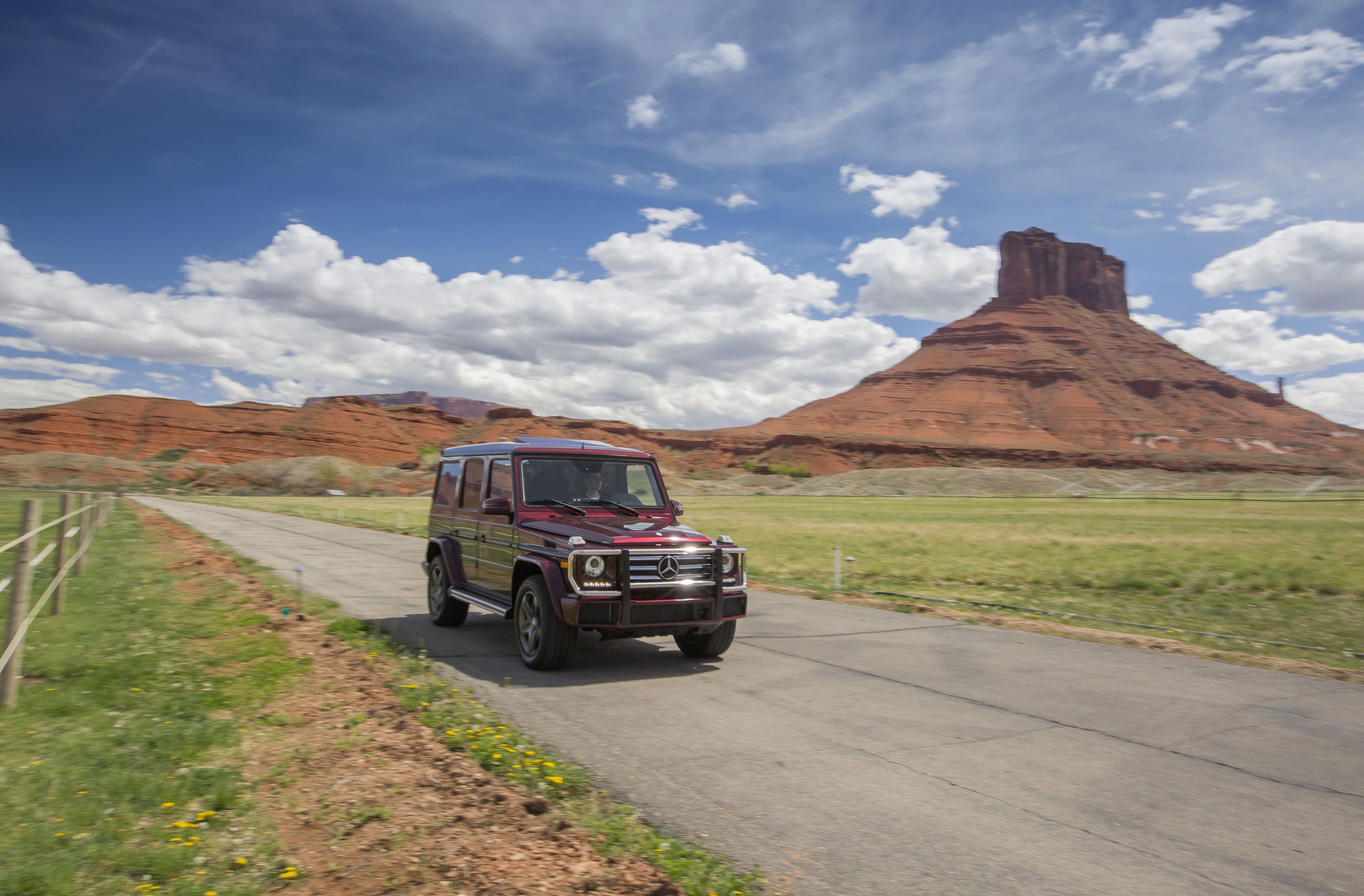 Mercedes-Benz G 550 driving on a road in a desert landscape HD Wallpaper