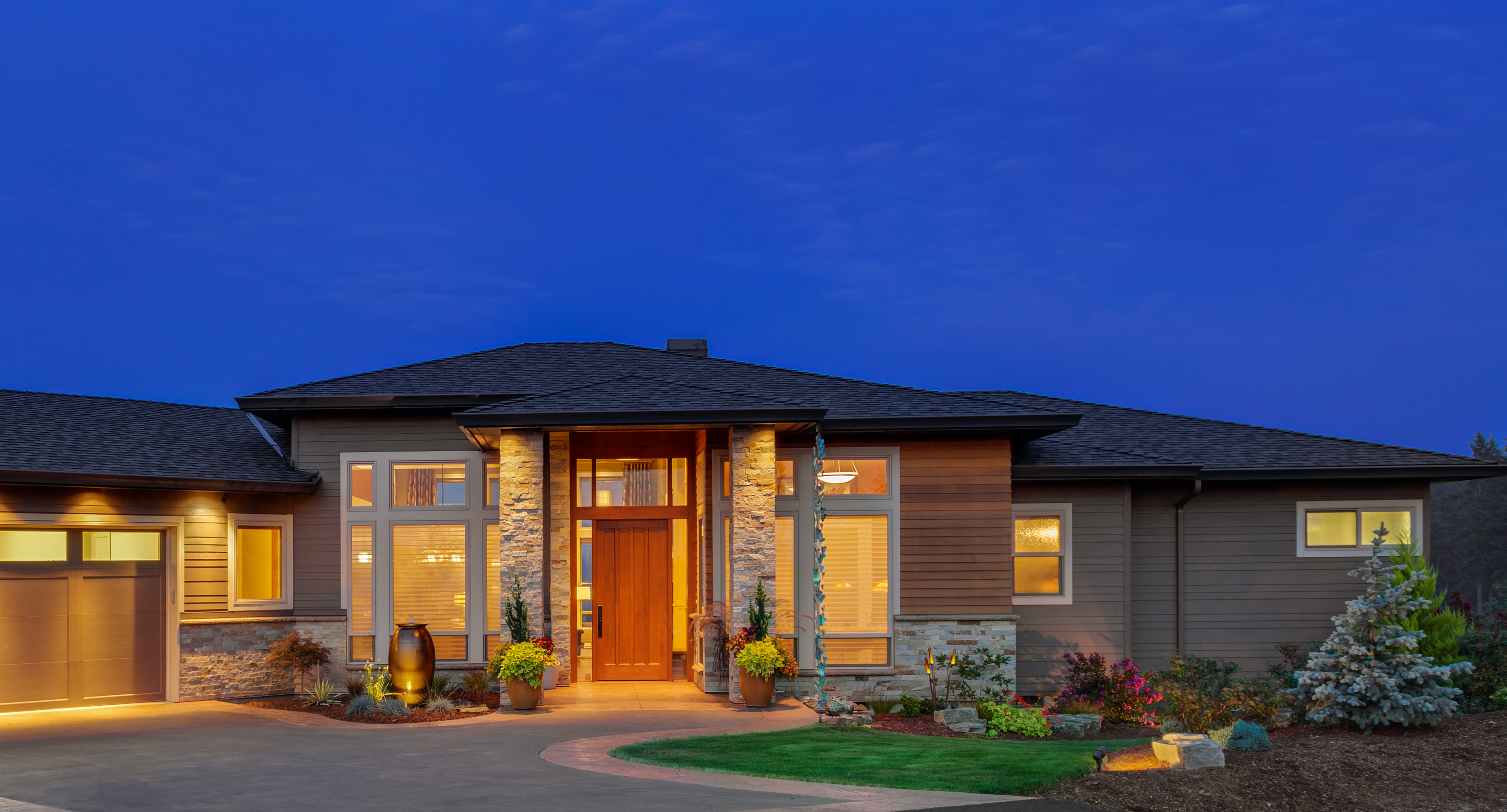 Modern House Exterior at Dusk with Garage and Landscaping HD Wallpaper