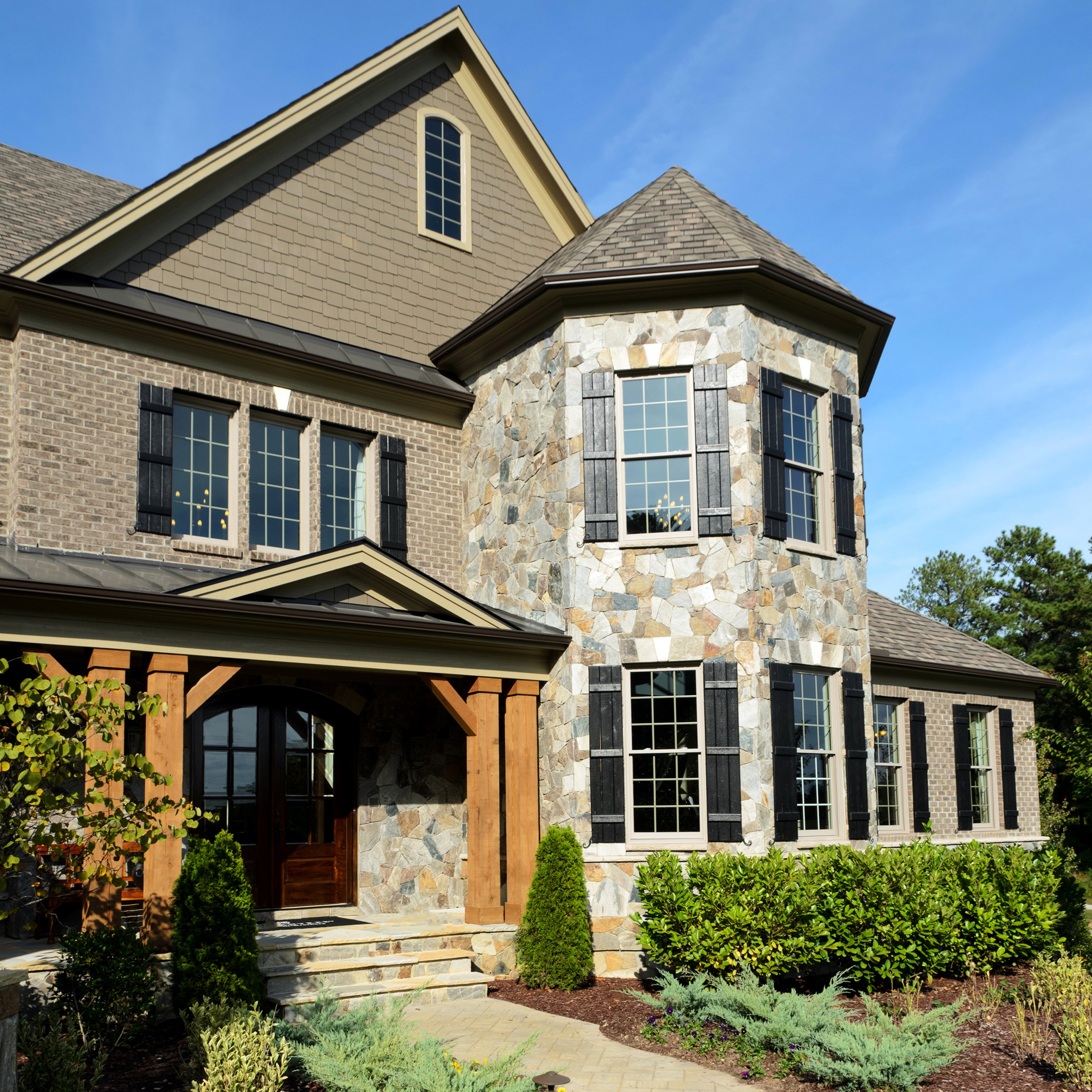 Luxury stone and brick house with wooden porch HD Wallpaper