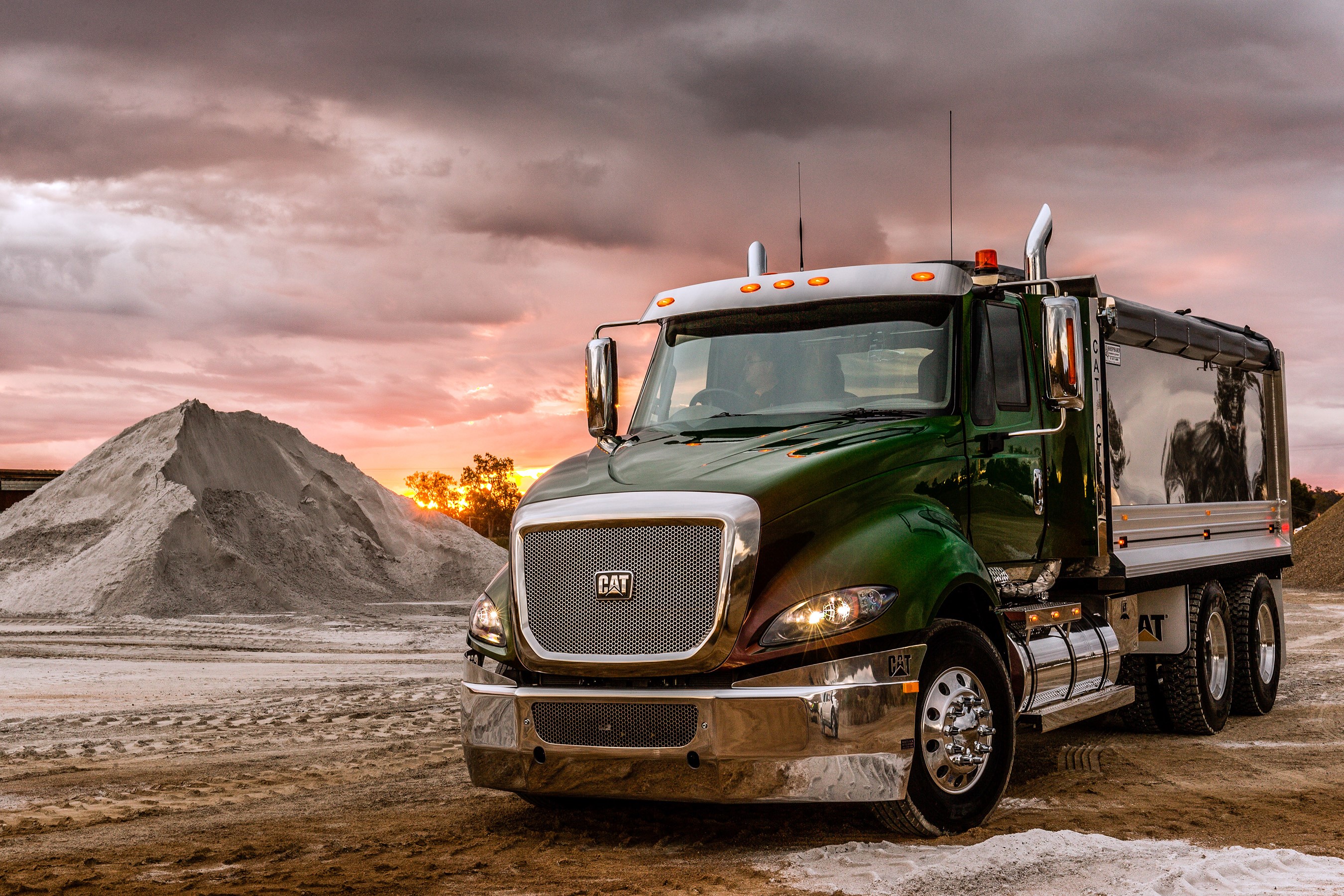 Caterpillar CT630 dump truck at sunset HD Wallpaper