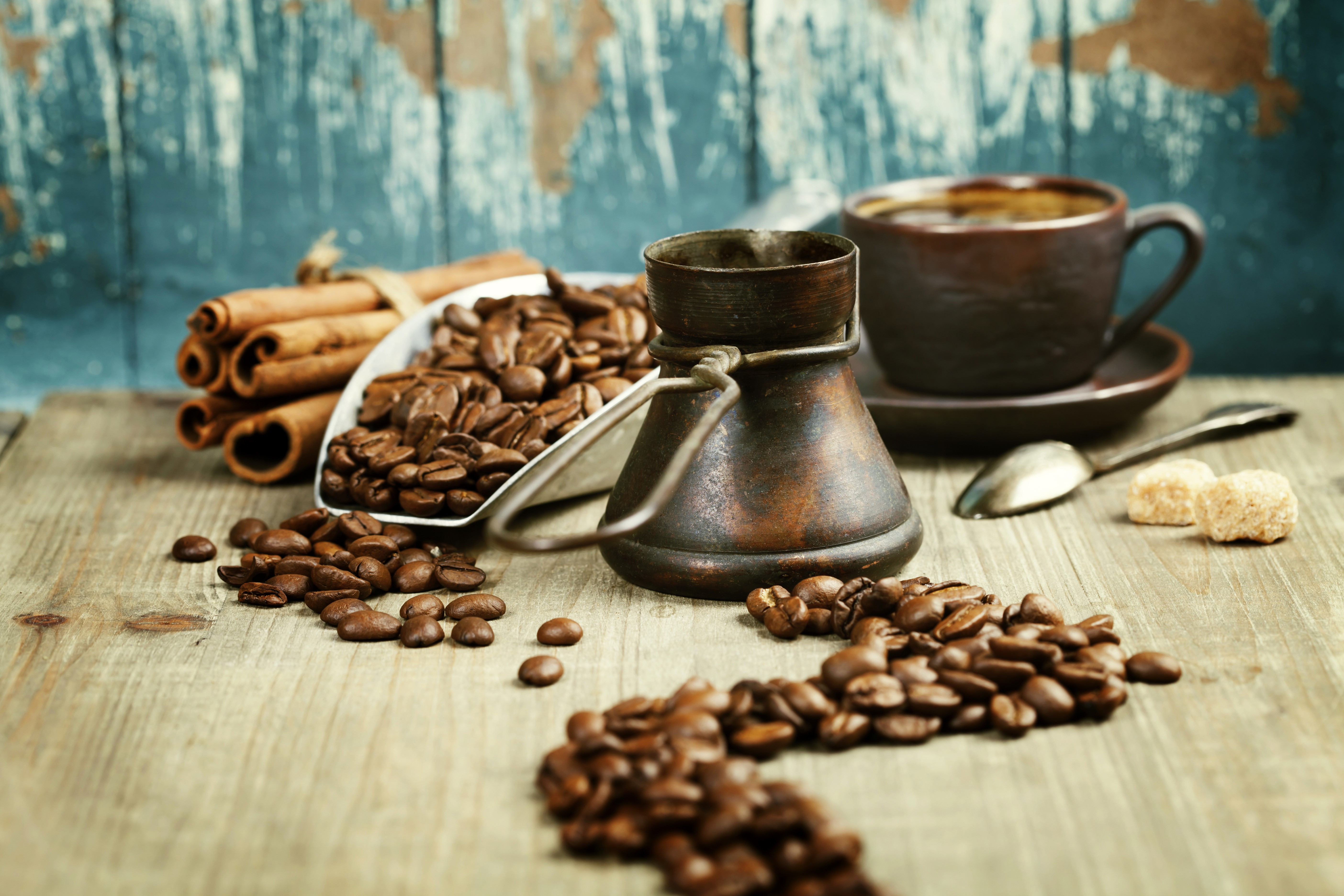 Coffee beans, cinnamon sticks, and a cup of coffee HD Wallpaper