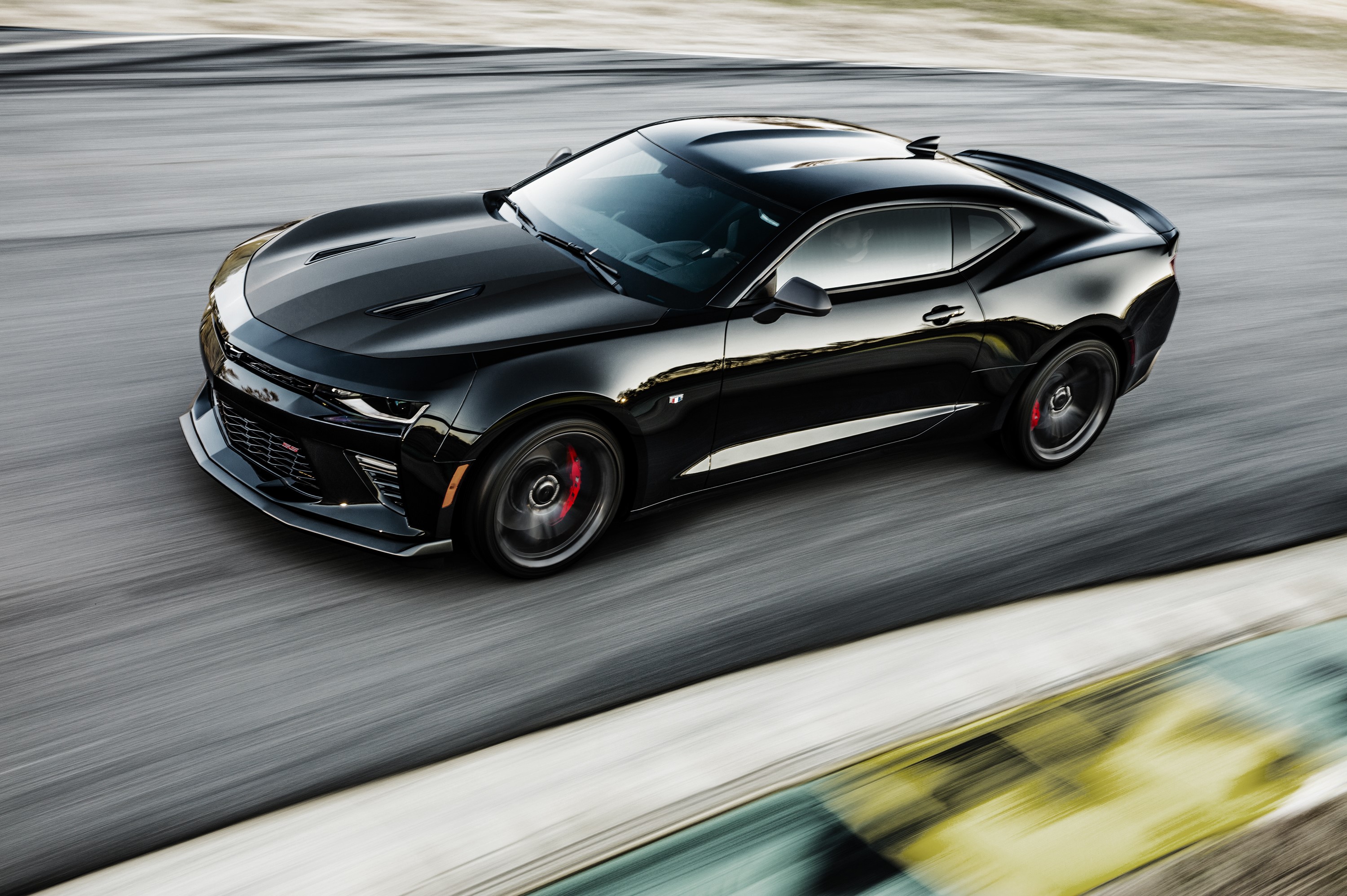 Black Chevrolet Camaro driving on a track HD Wallpaper