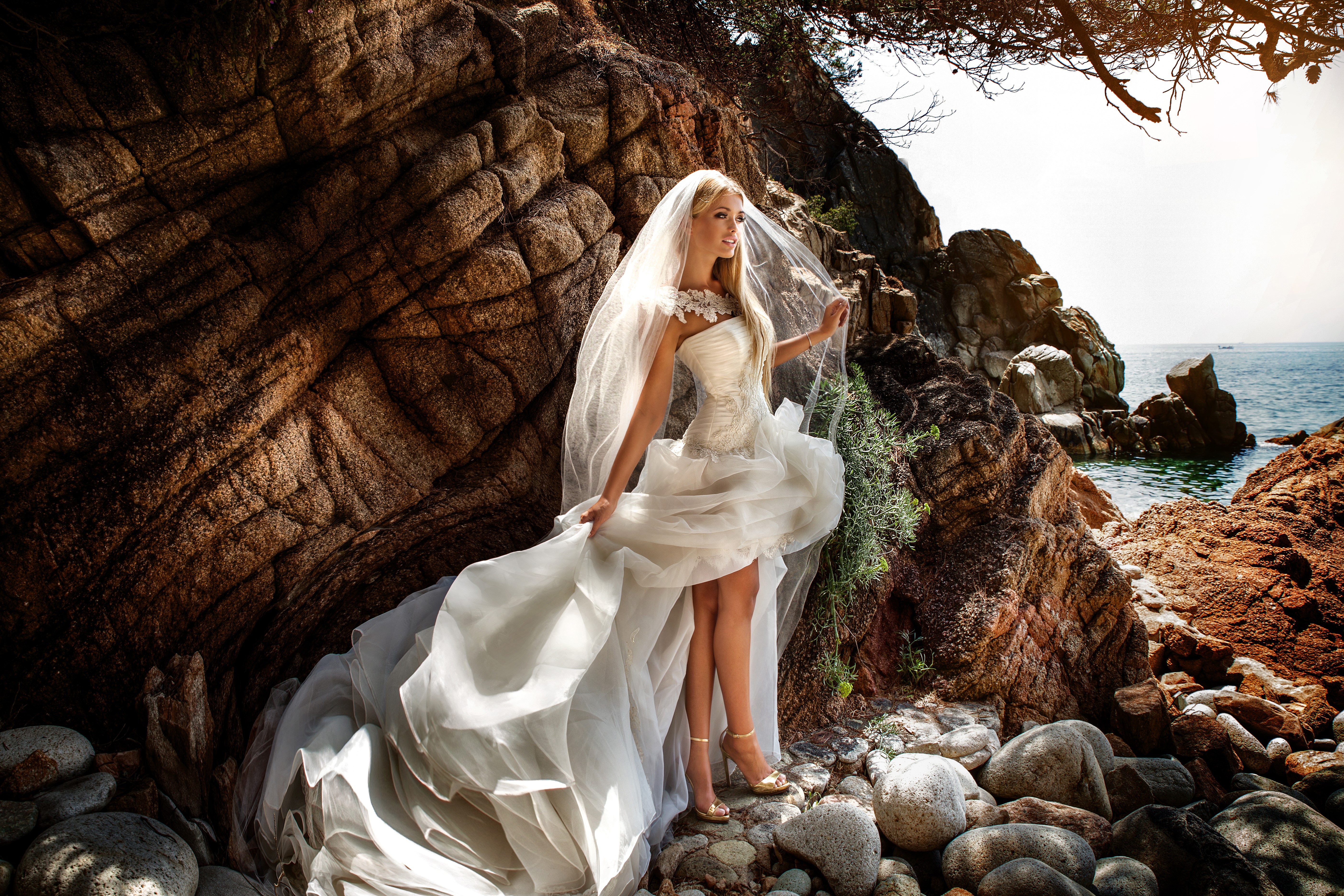 Bride in a white dress on a rocky beach HD Wallpaper