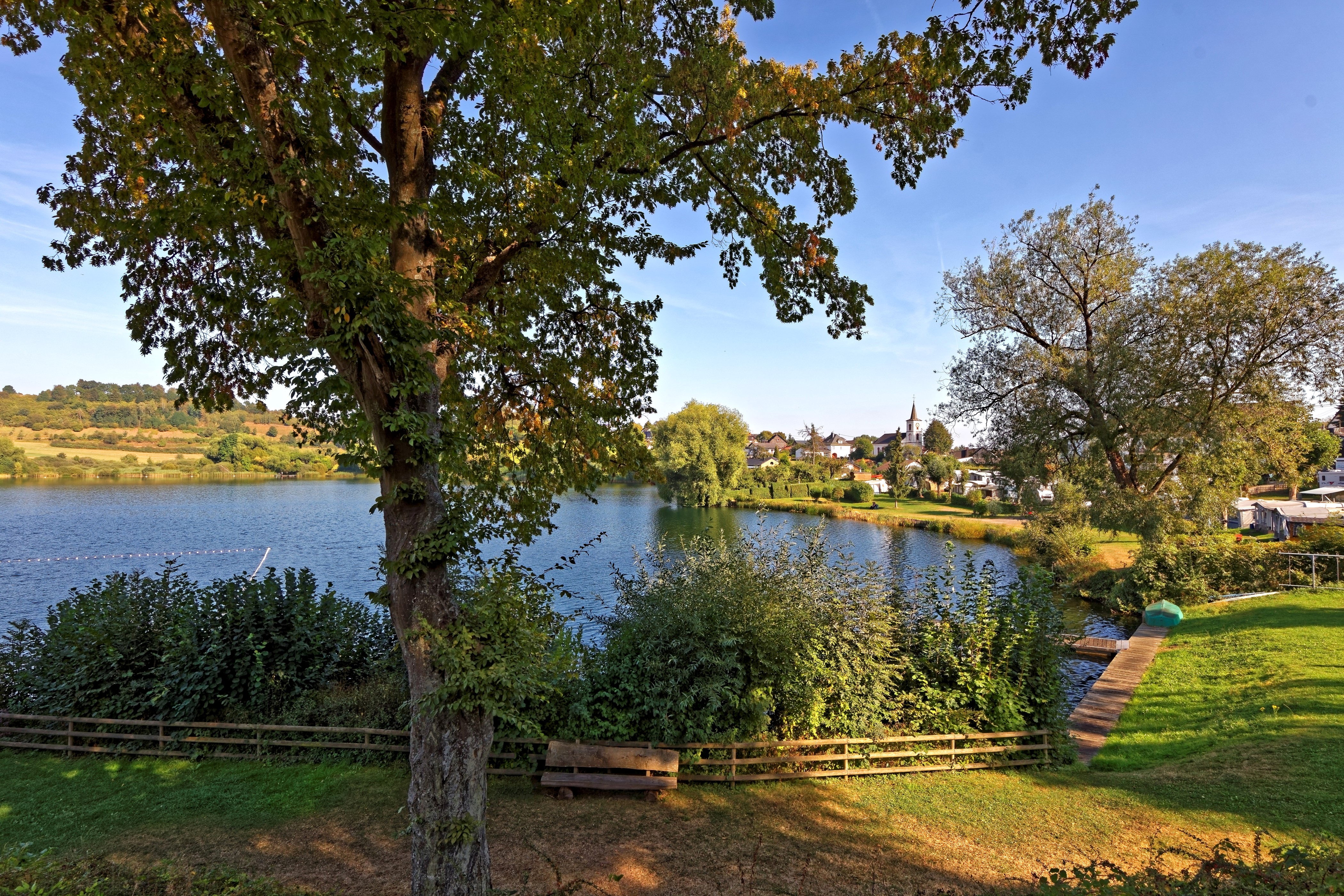 4K Schalkenmehrener Lake with Village and Trees HD Wallpaper