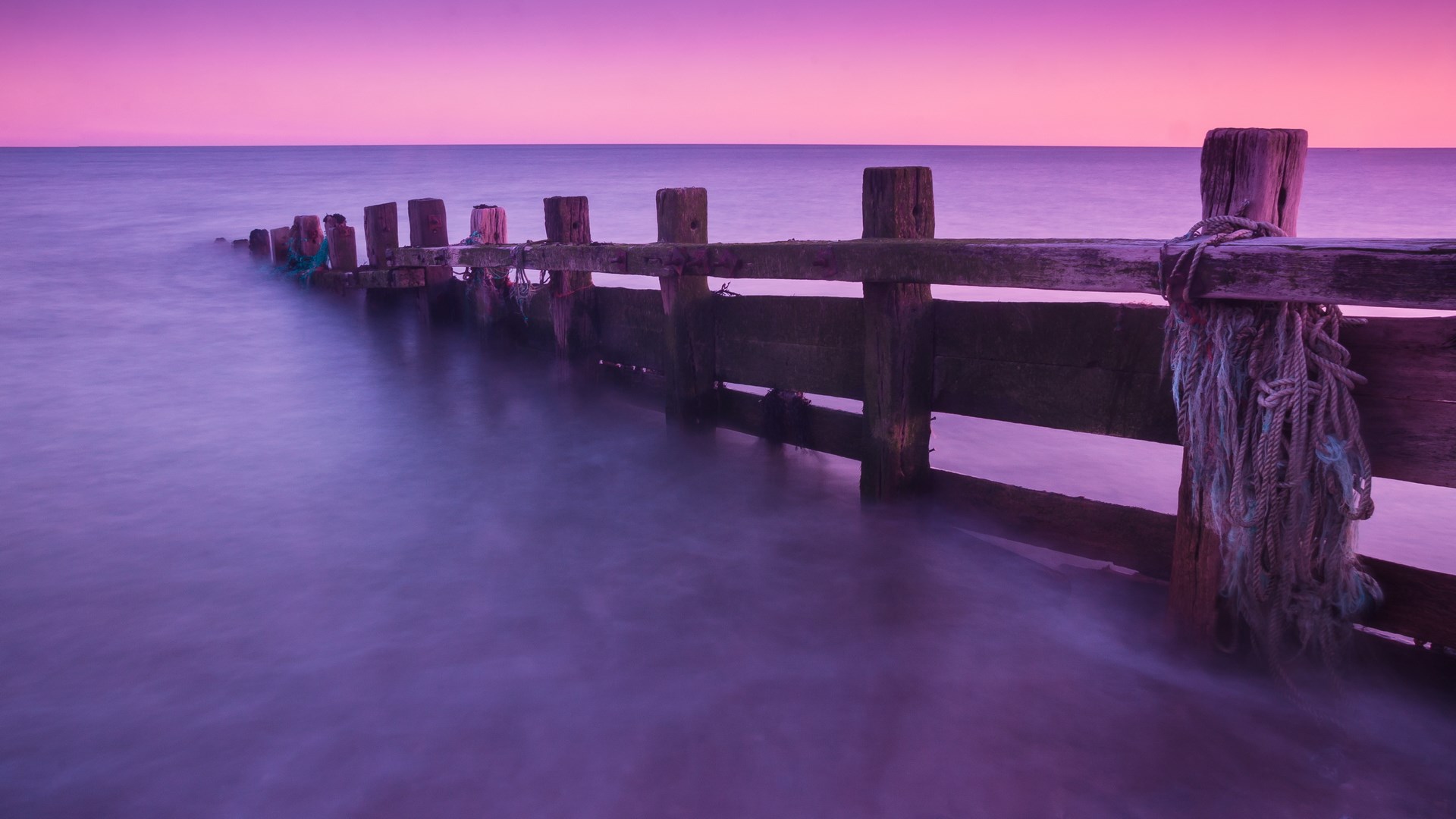 Wooden pier with ropes at sunset HD Wallpaper