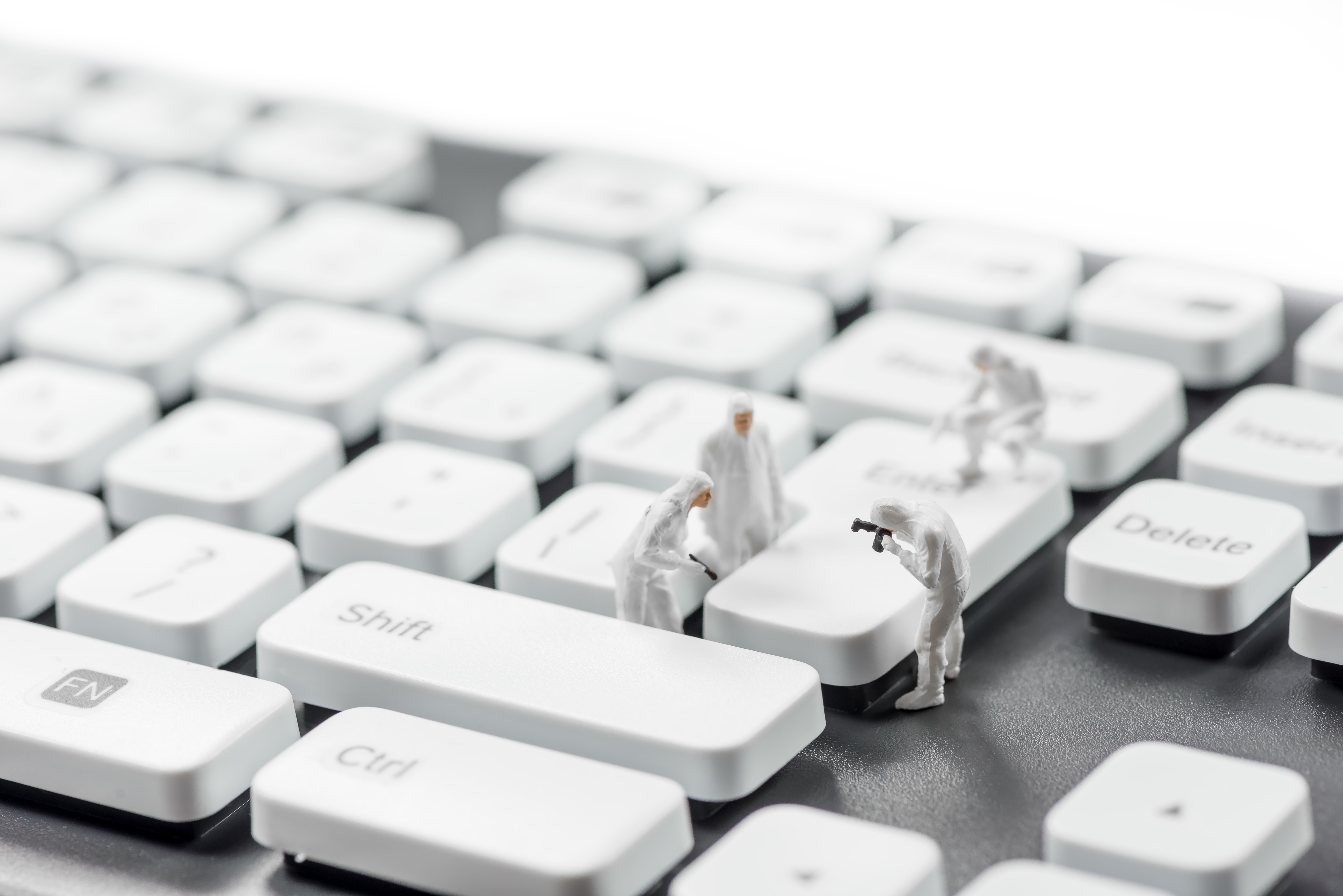 Miniature crime scene investigators on a keyboard HD Wallpaper