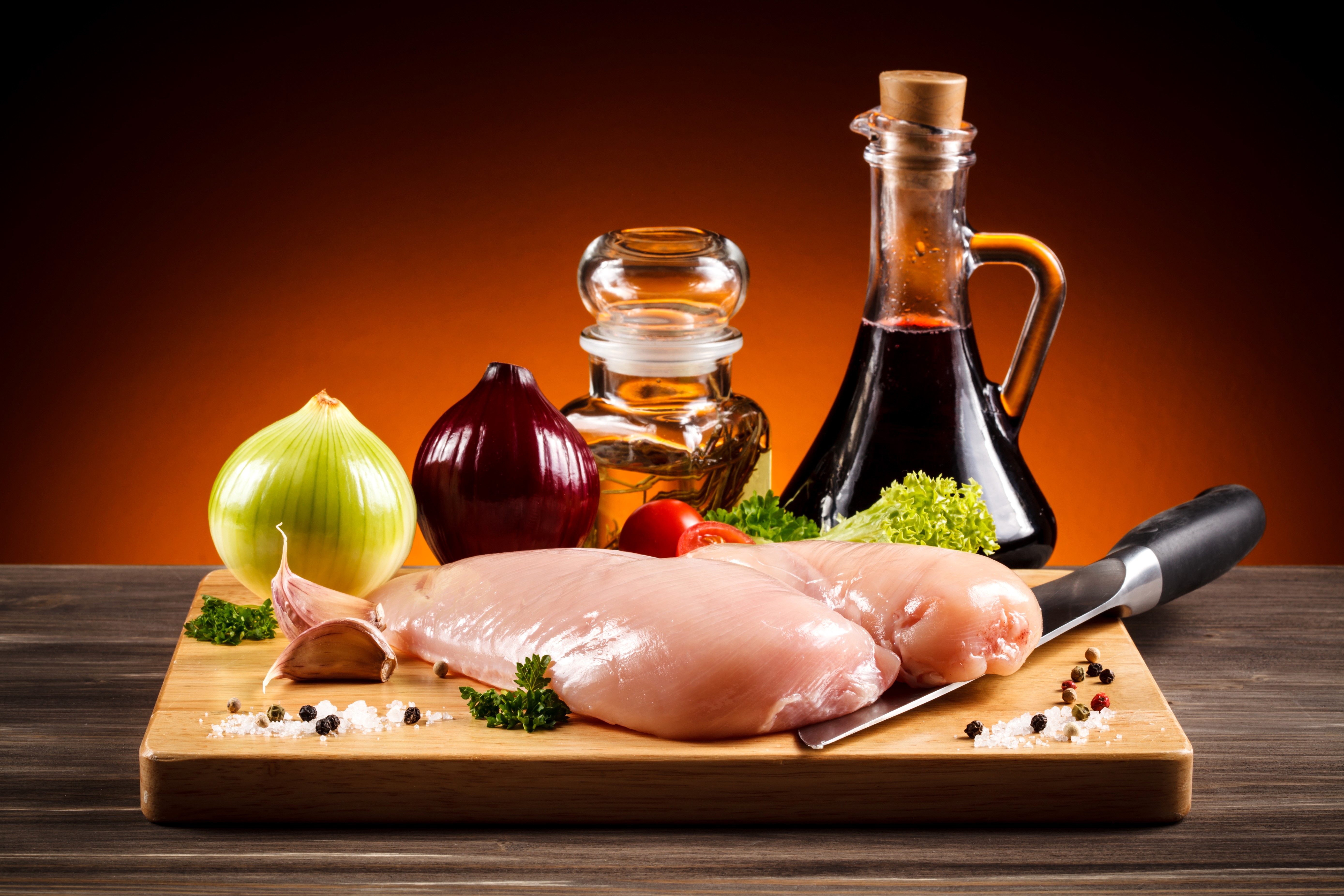Still-life of chicken, onions, garlic, and oils HD Wallpaper