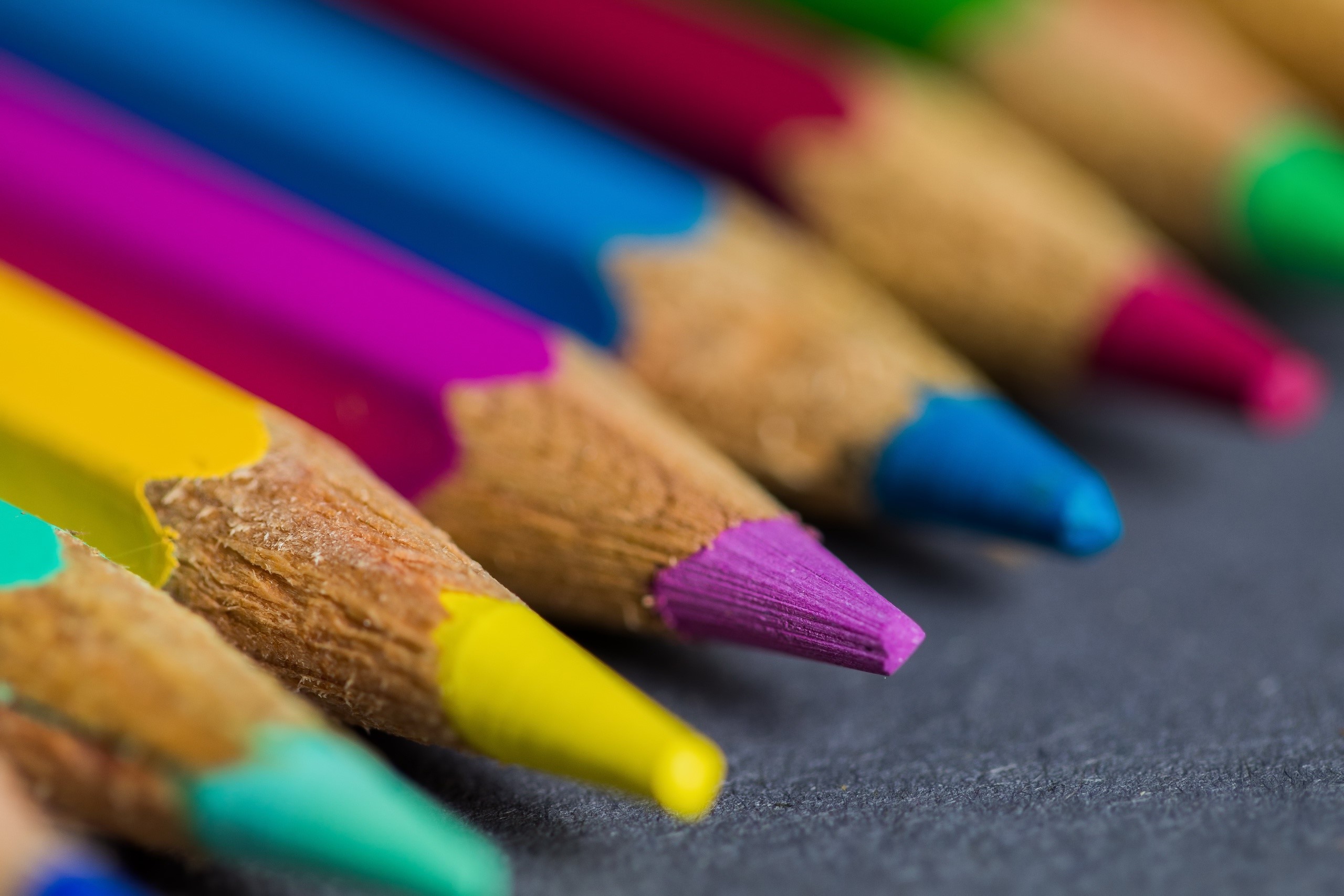 Macro shot of colored pencils on a dark surface HD Wallpaper