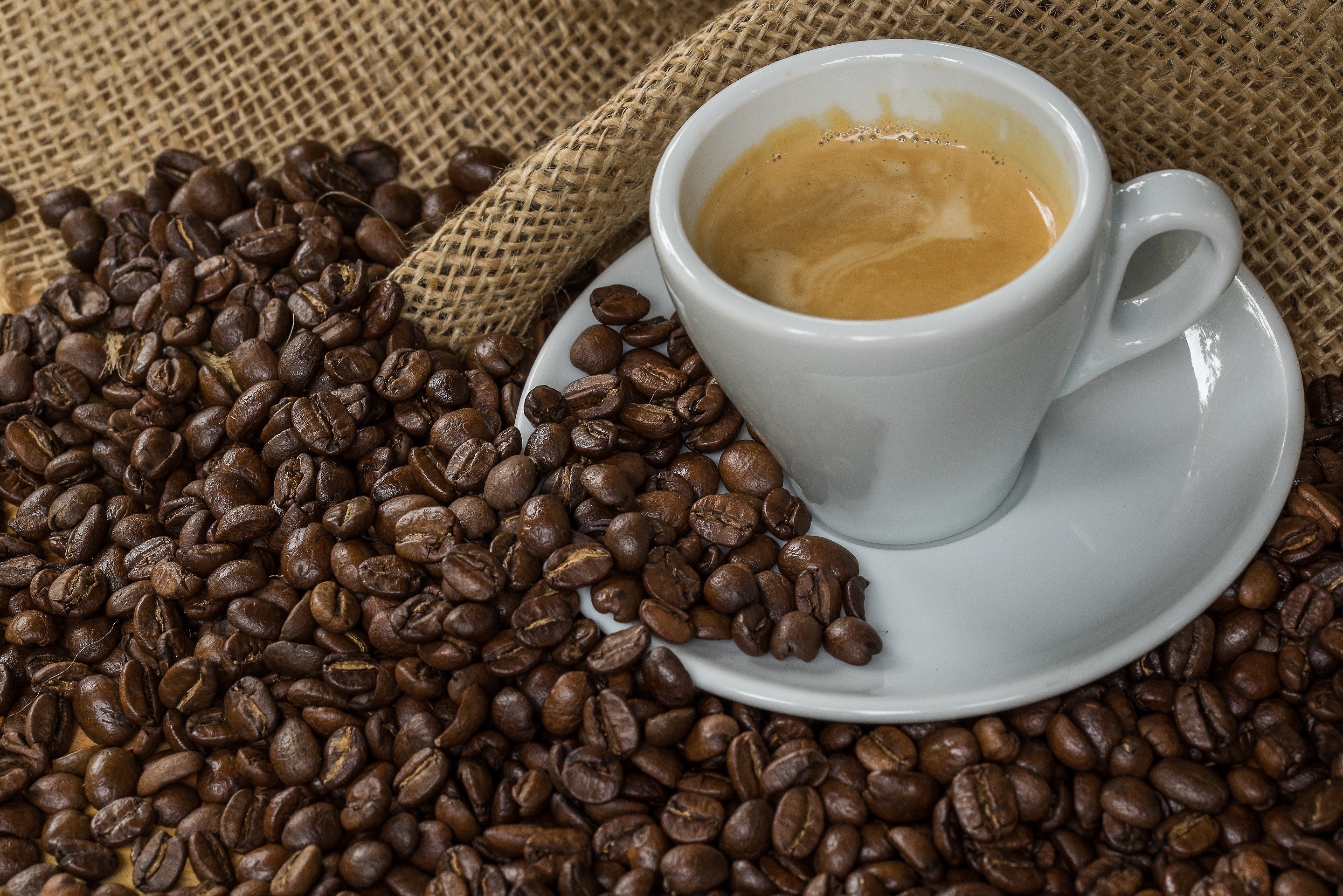 Espresso cup with coffee beans and burlap HD Wallpaper