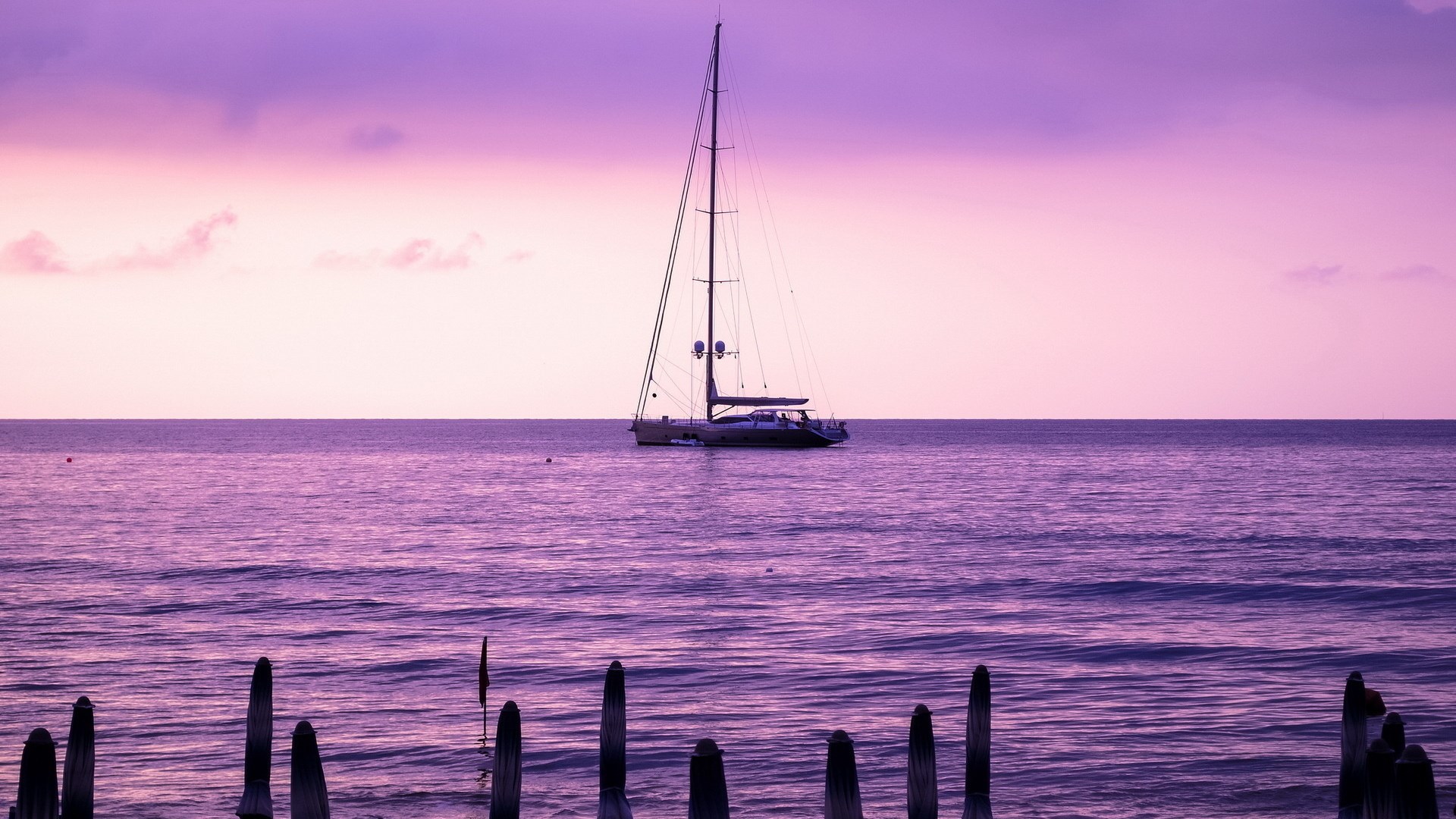 Sailboat on purple ocean at sunset HD Wallpaper