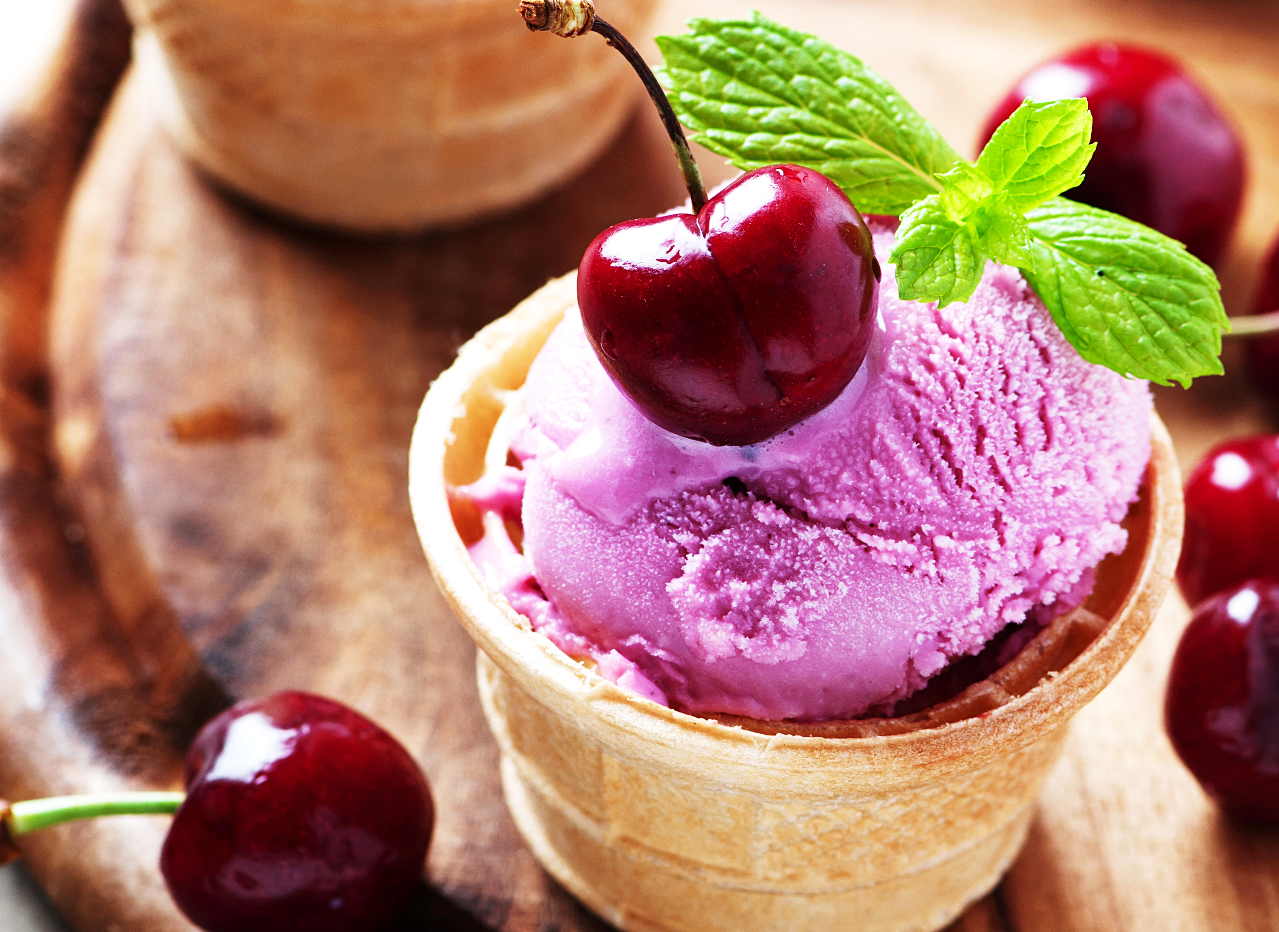 Cherry ice cream in a waffle cone with mint HD Wallpaper