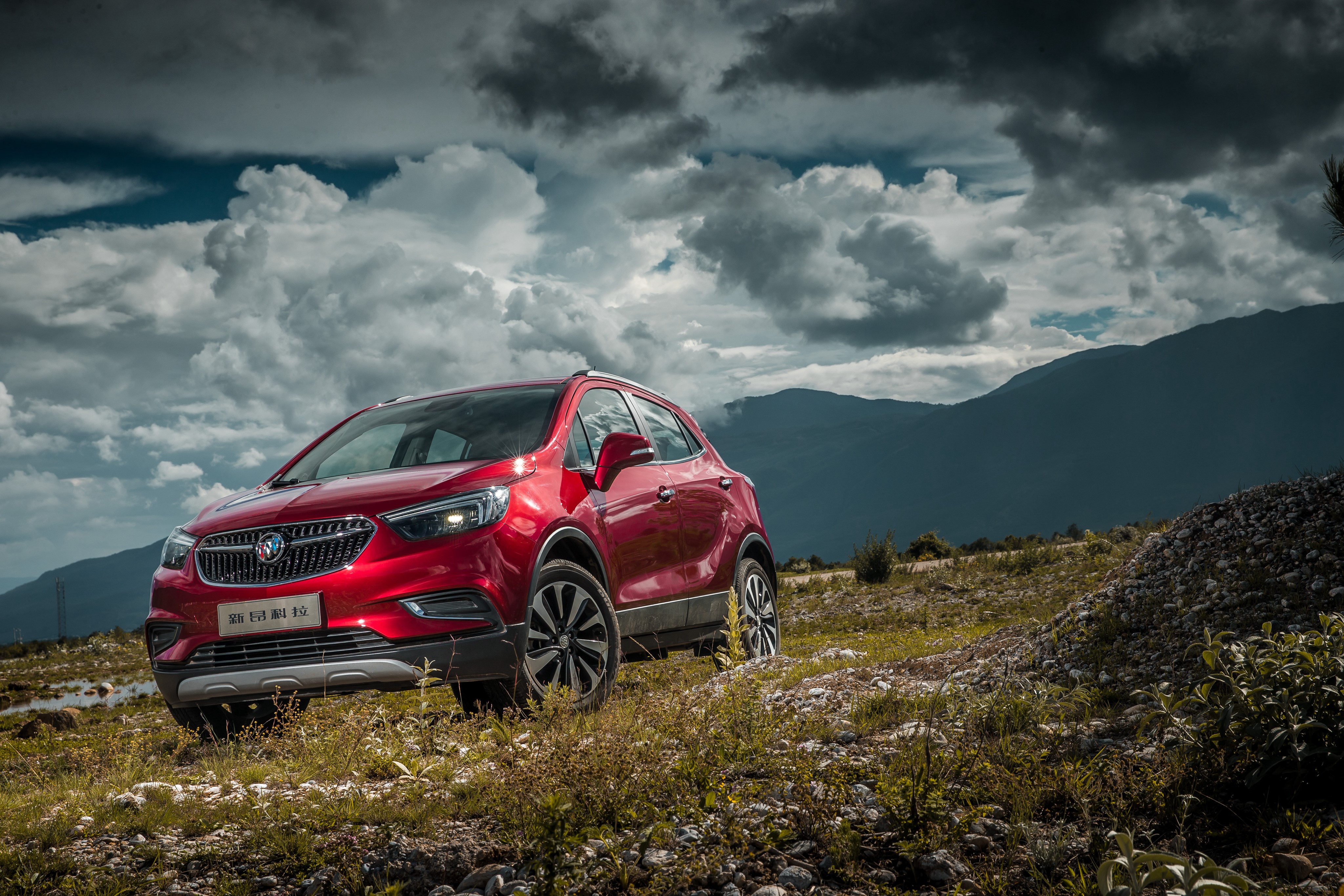 Red Buick Encore on a rocky hill HD Wallpaper