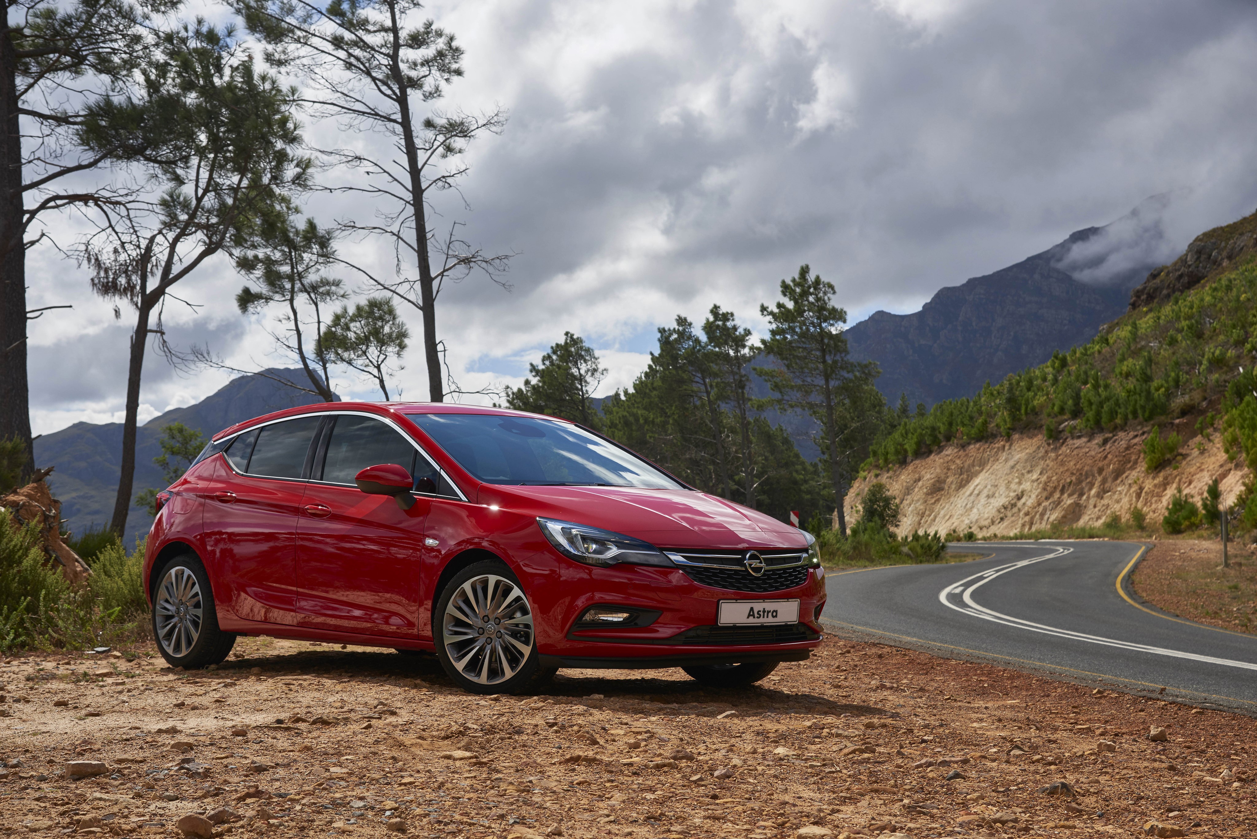 Red 2016 Opel Astra parked on a dirt road HD Wallpaper