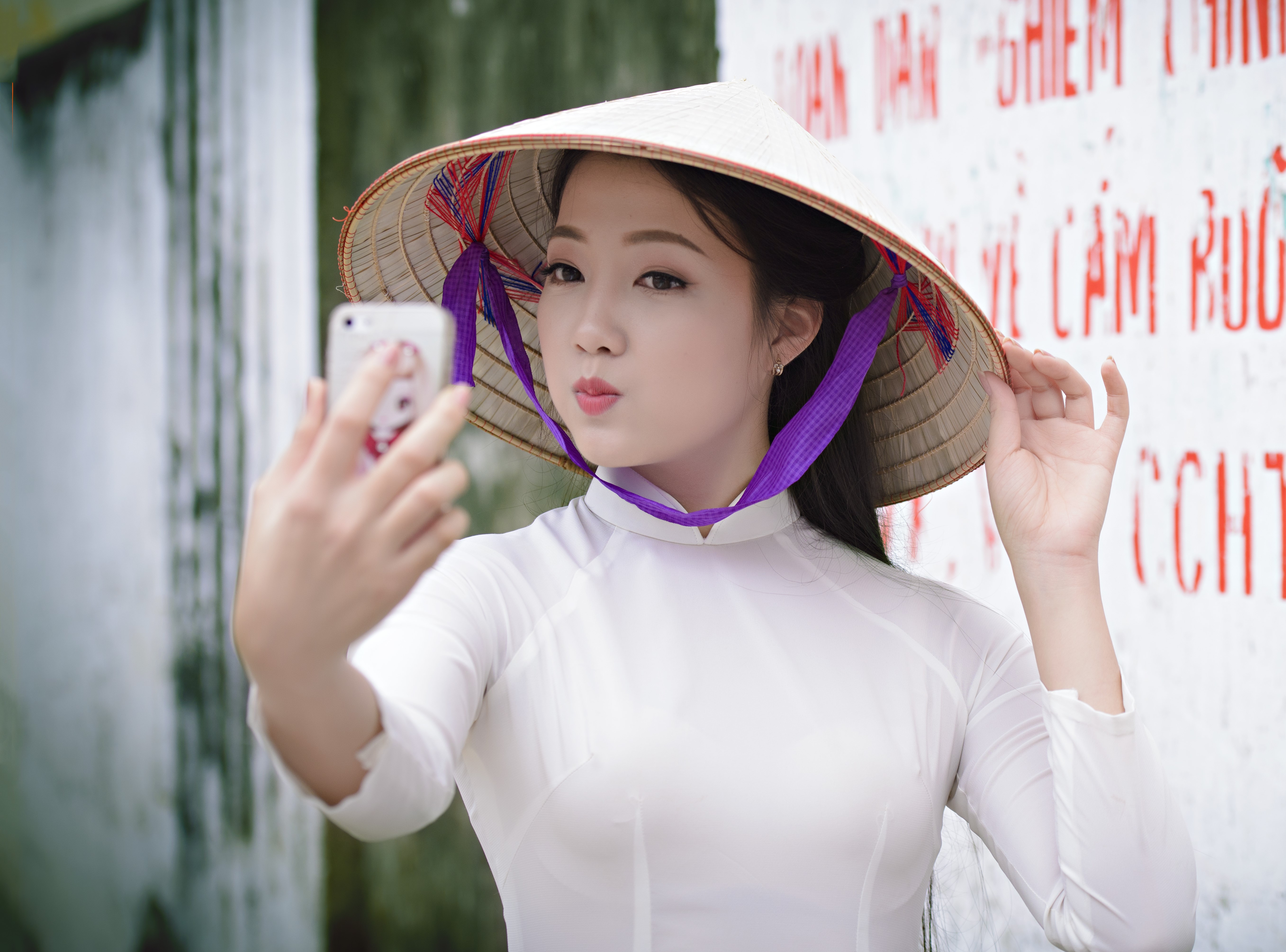 Asian woman in conical hat taking a selfie HD Wallpaper