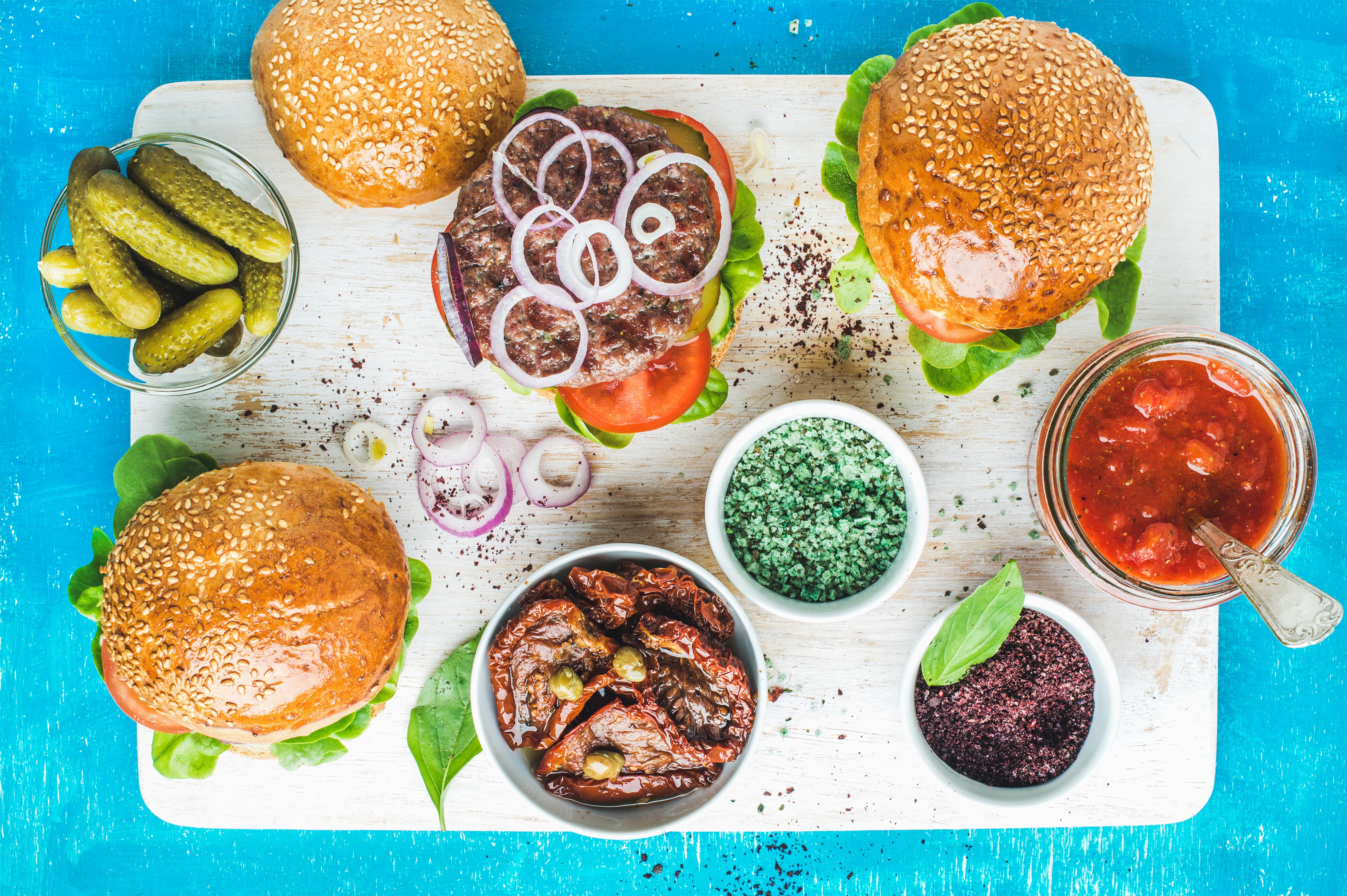 Hamburger ingredients on a cutting board HD Wallpaper