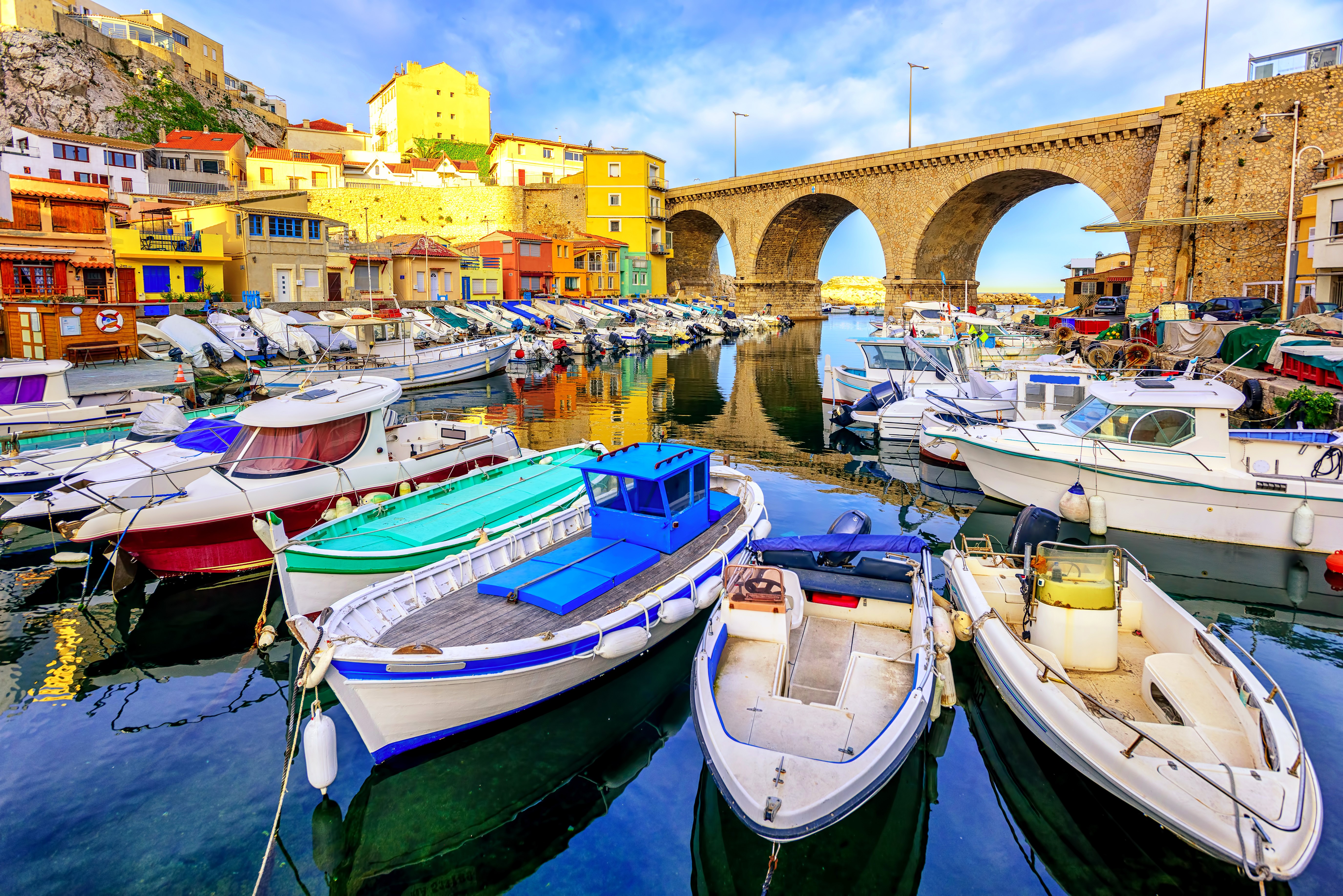 Boats in a harbor with a stone bridge in Marseille, France HD Wallpaper