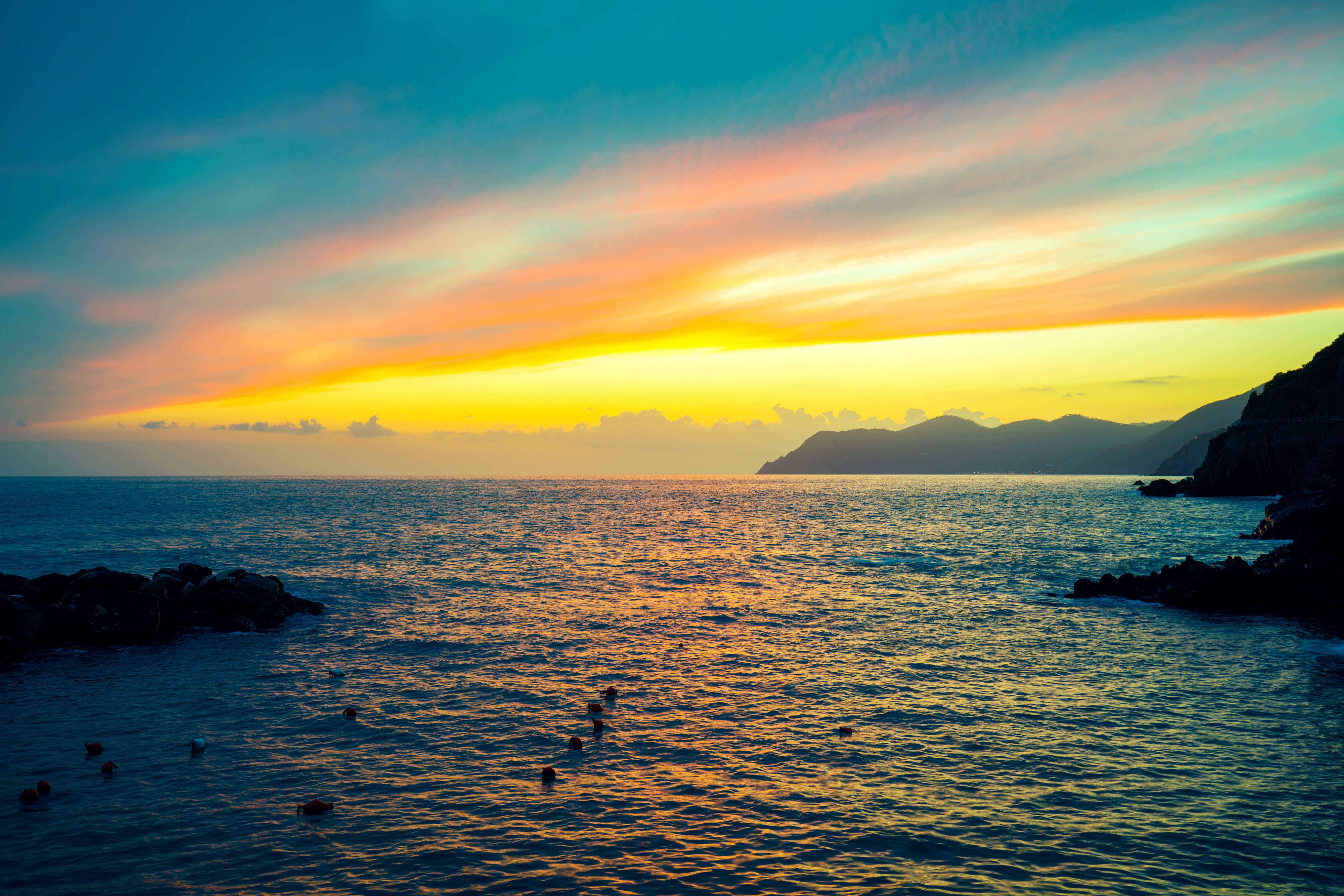 Sunset over the sea with mountains HD Wallpaper