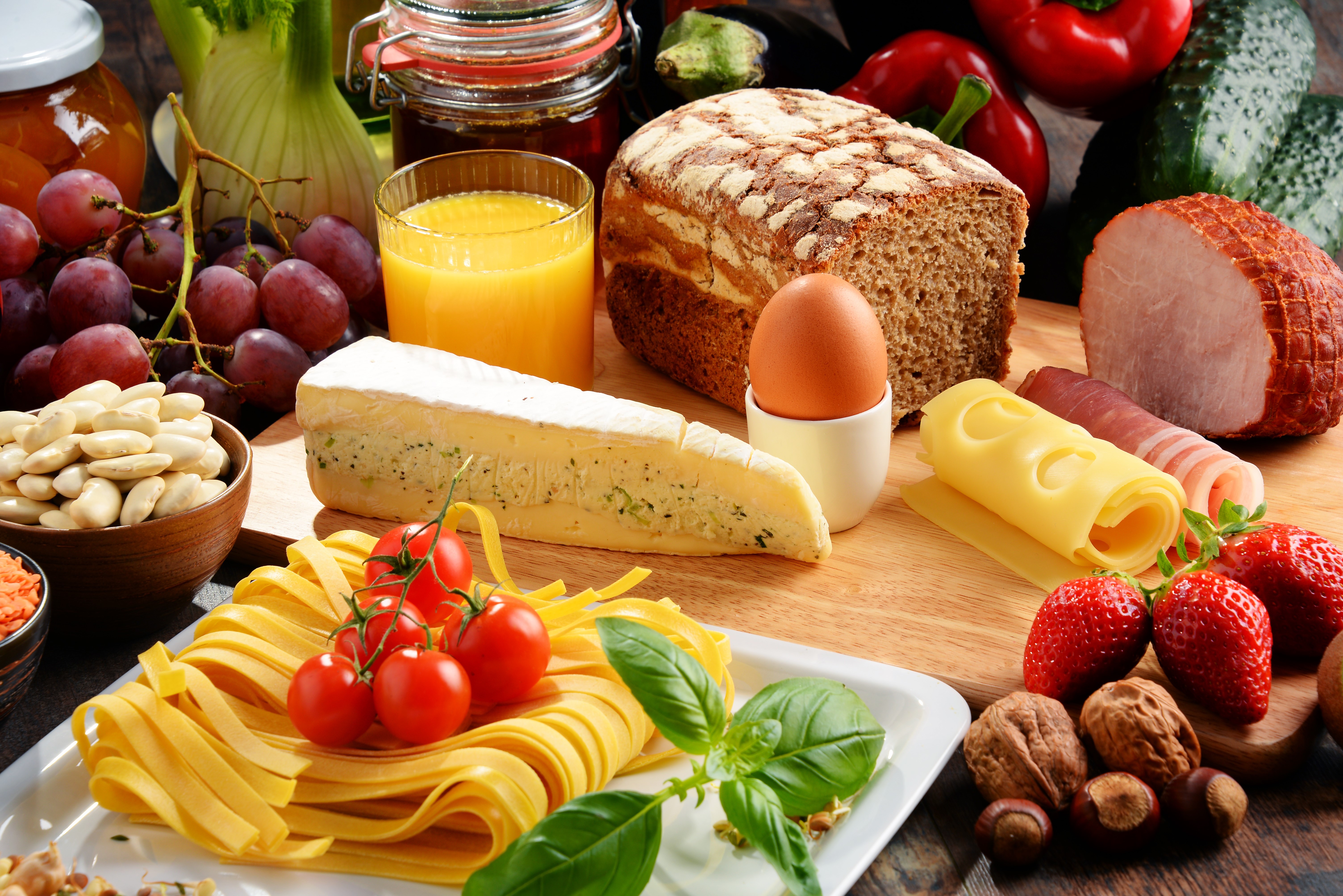 Still-life of bread, cheese, ham, eggs, juice, and fruits HD Wallpaper