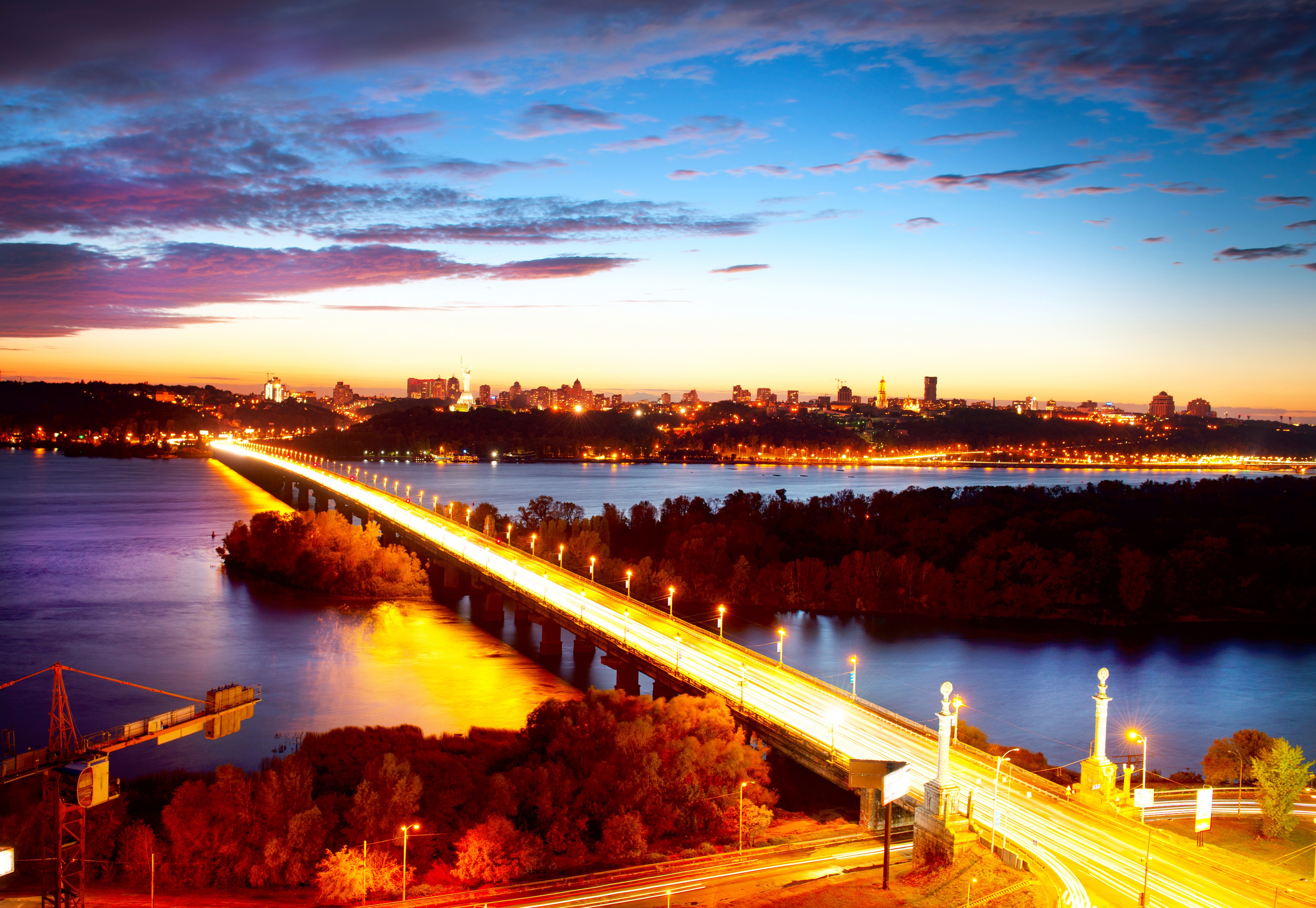 Kyiv cityscape with bridge over river at night HD Wallpaper