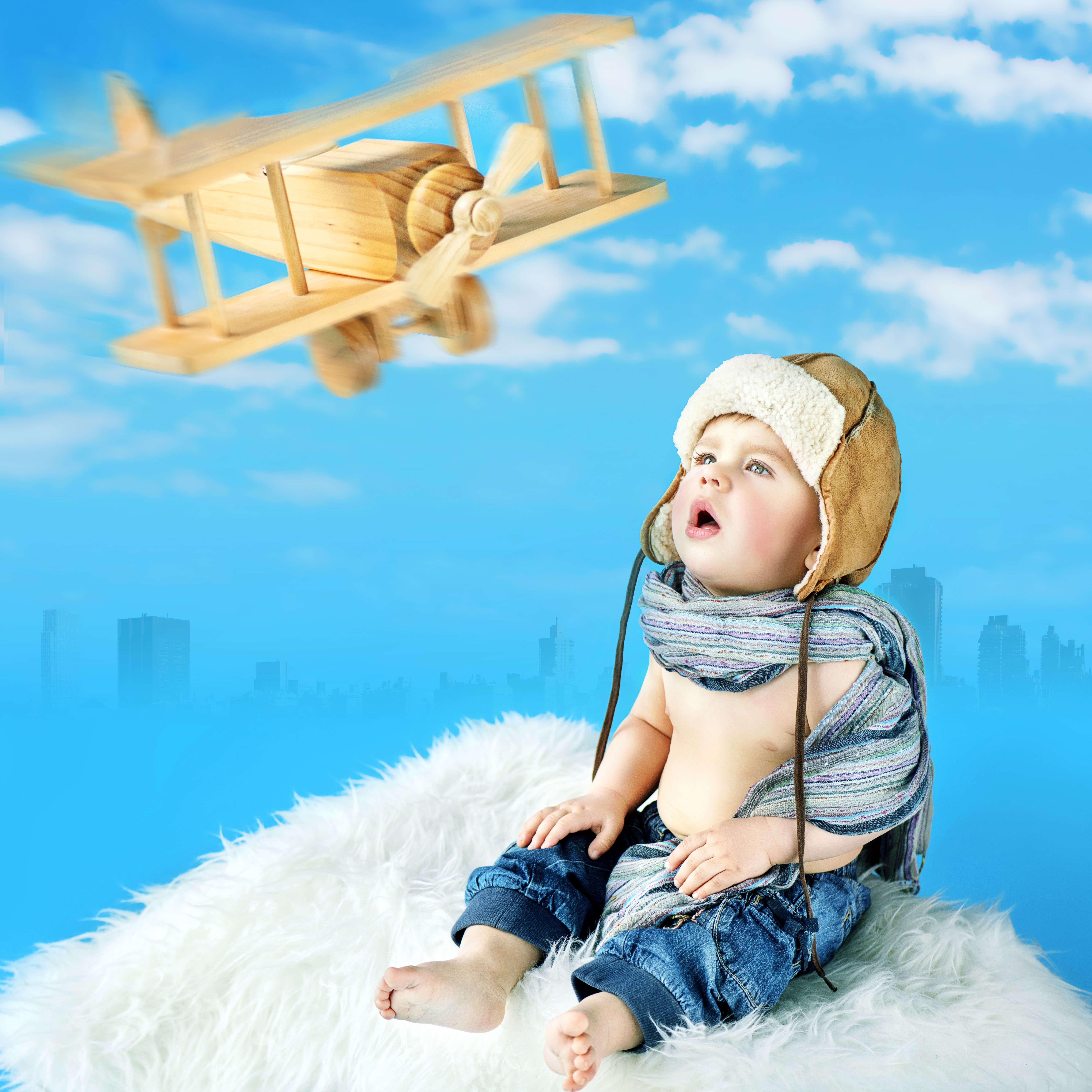 Baby looking at a toy airplane HD Wallpaper