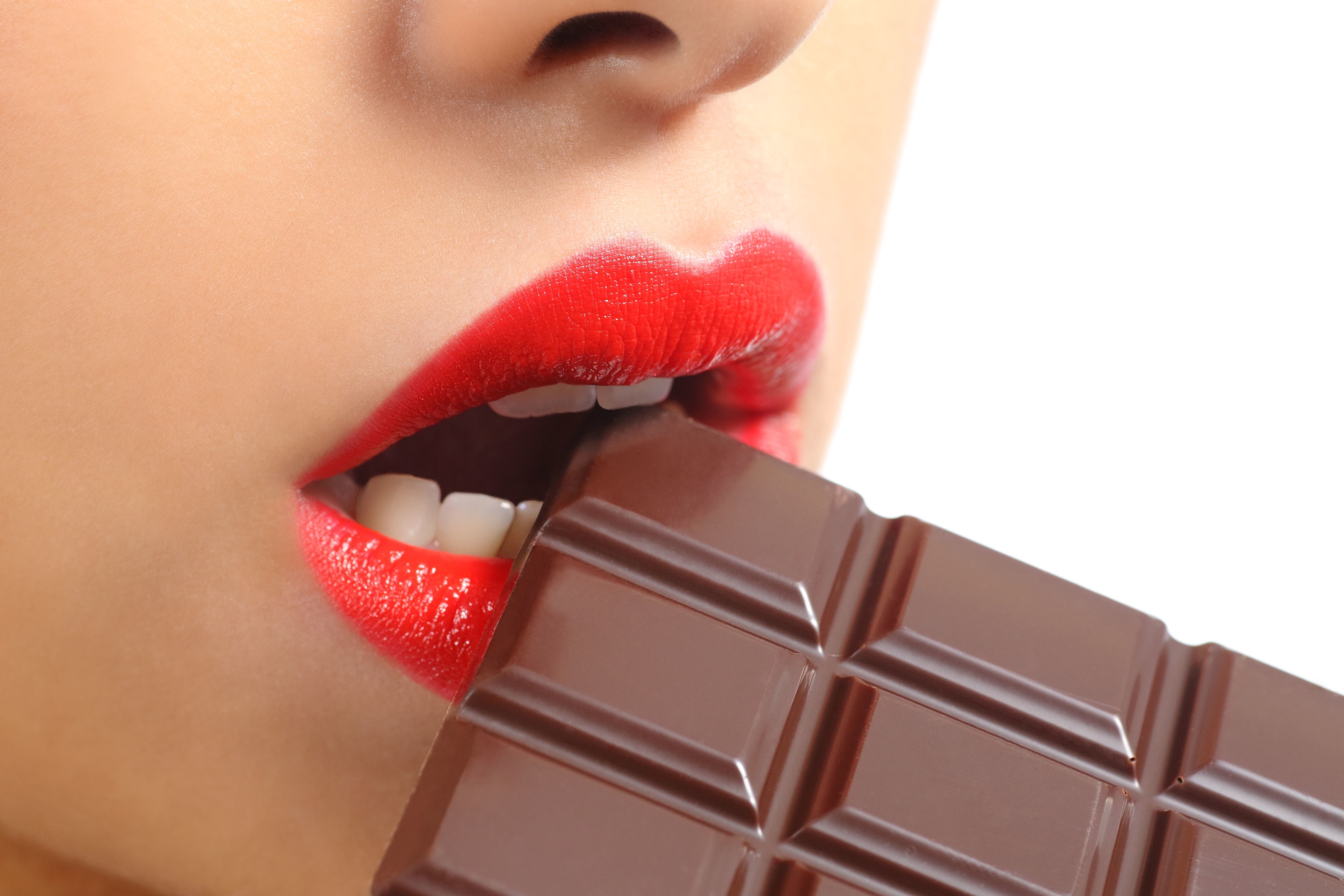 Woman with red lips eating chocolate bar HD Wallpaper