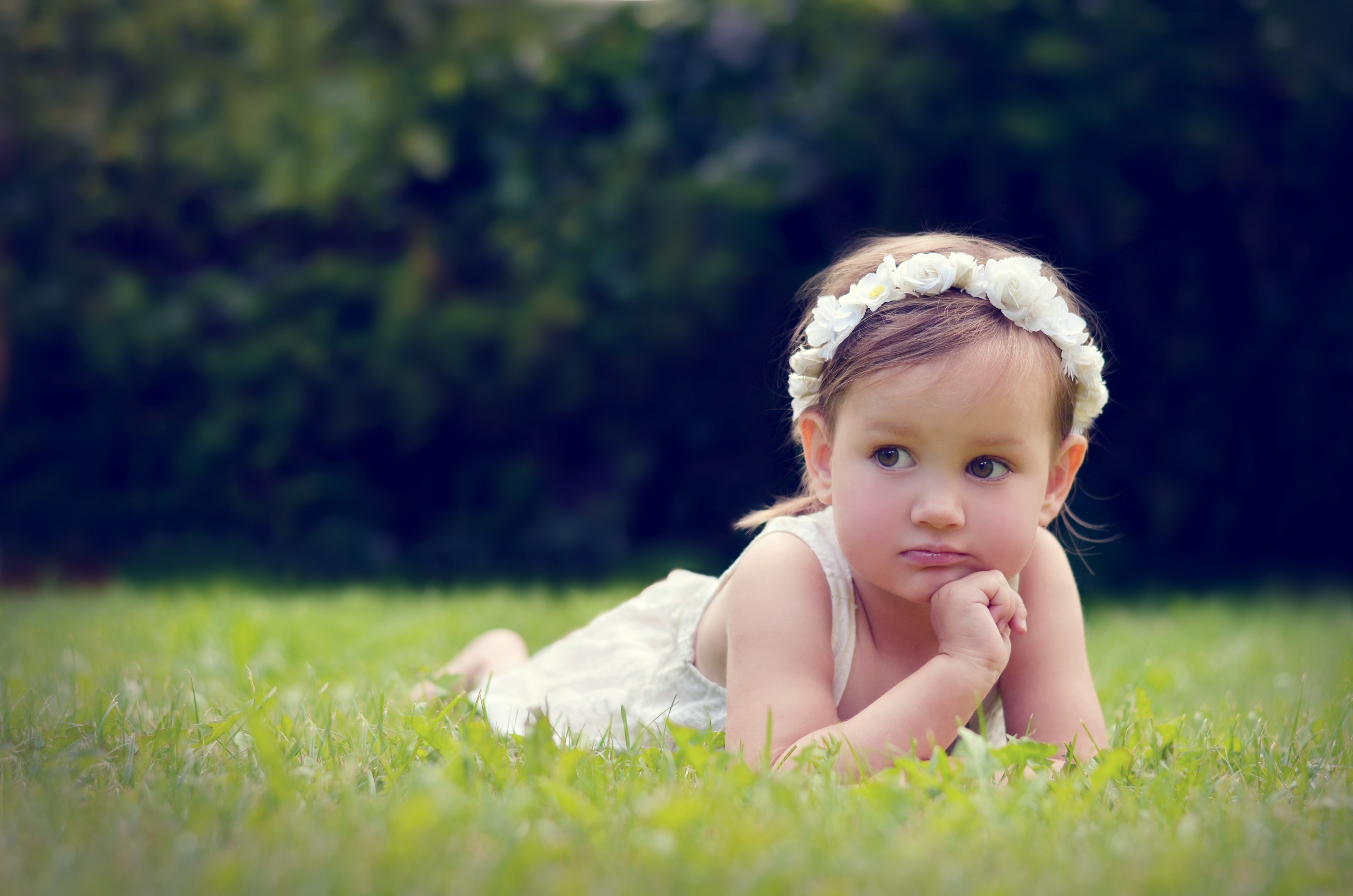 Little girl with flower crown on grass HD Wallpaper