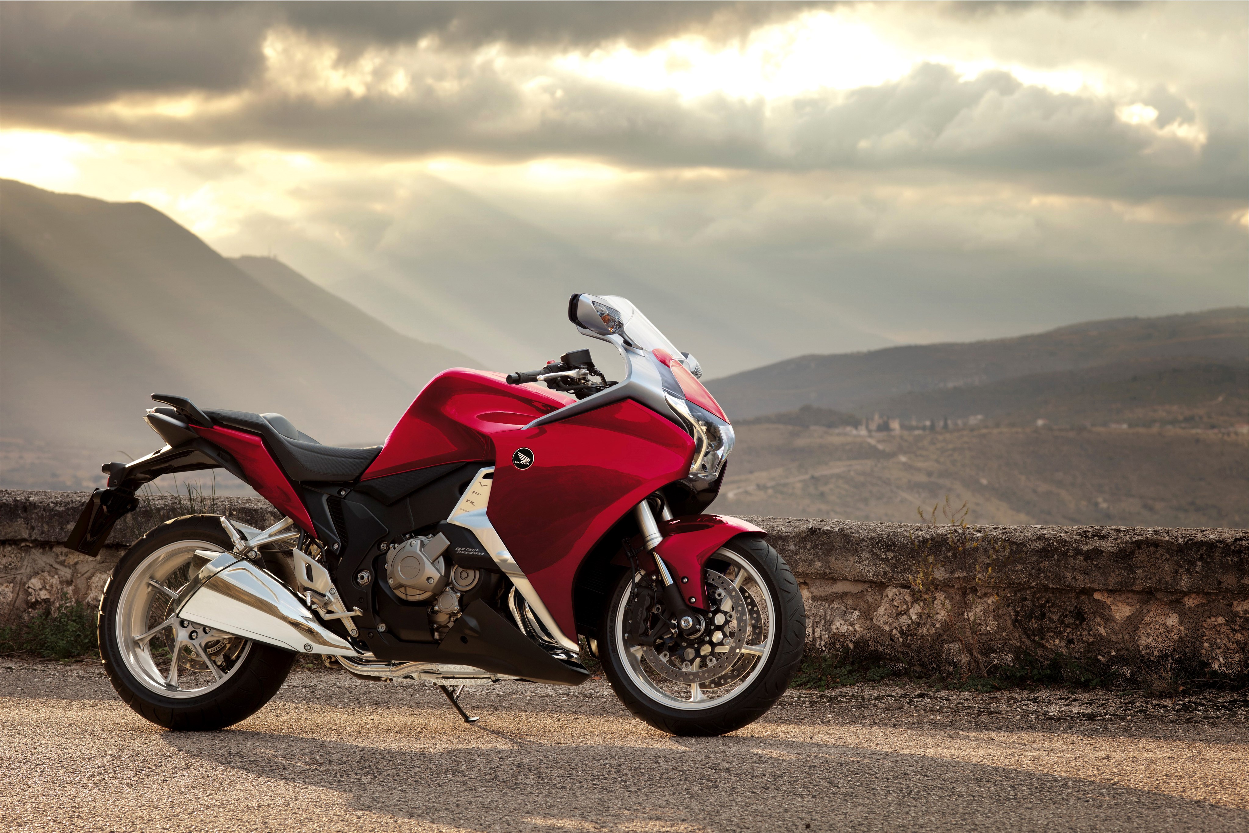 Red Honda VFR1200F motorcycle parked on a stone wall HD Wallpaper